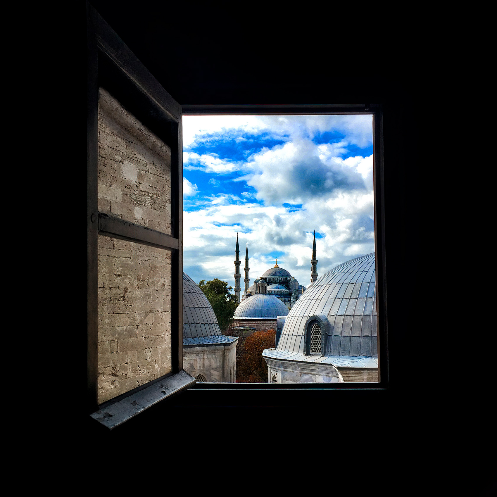 a beautiful view of the blue mosque from a window inside the hagia sofia mosque window in istanbul turkey.