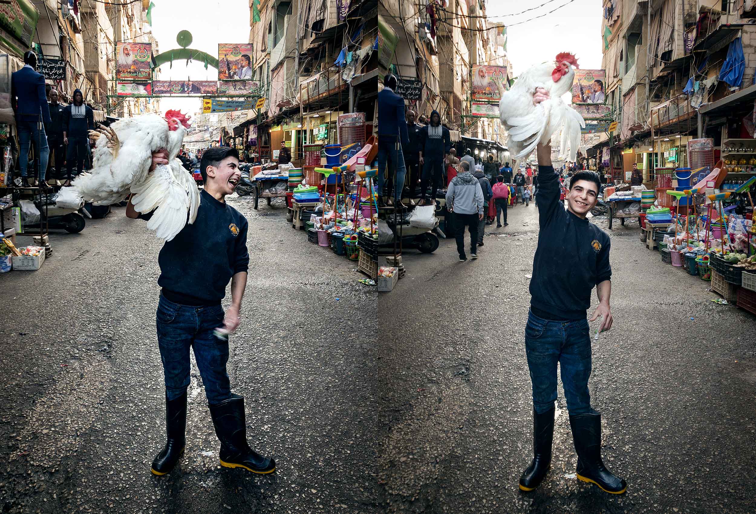  a boy holds a live chicken in the air in an open market in beirut 