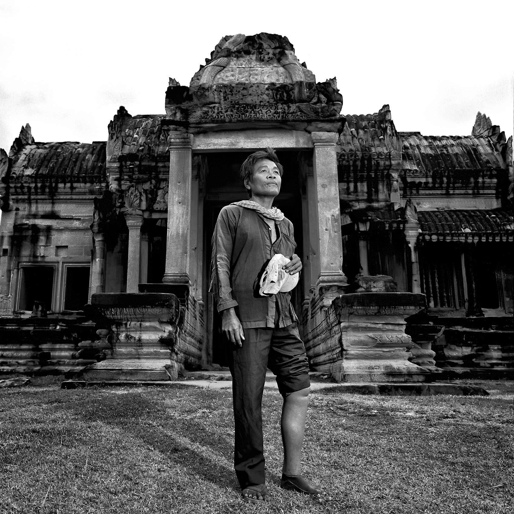 a-cambodian-man-who-was-a-victim-of-a-landmine-poses-for-a-photo-at-angkor-wat