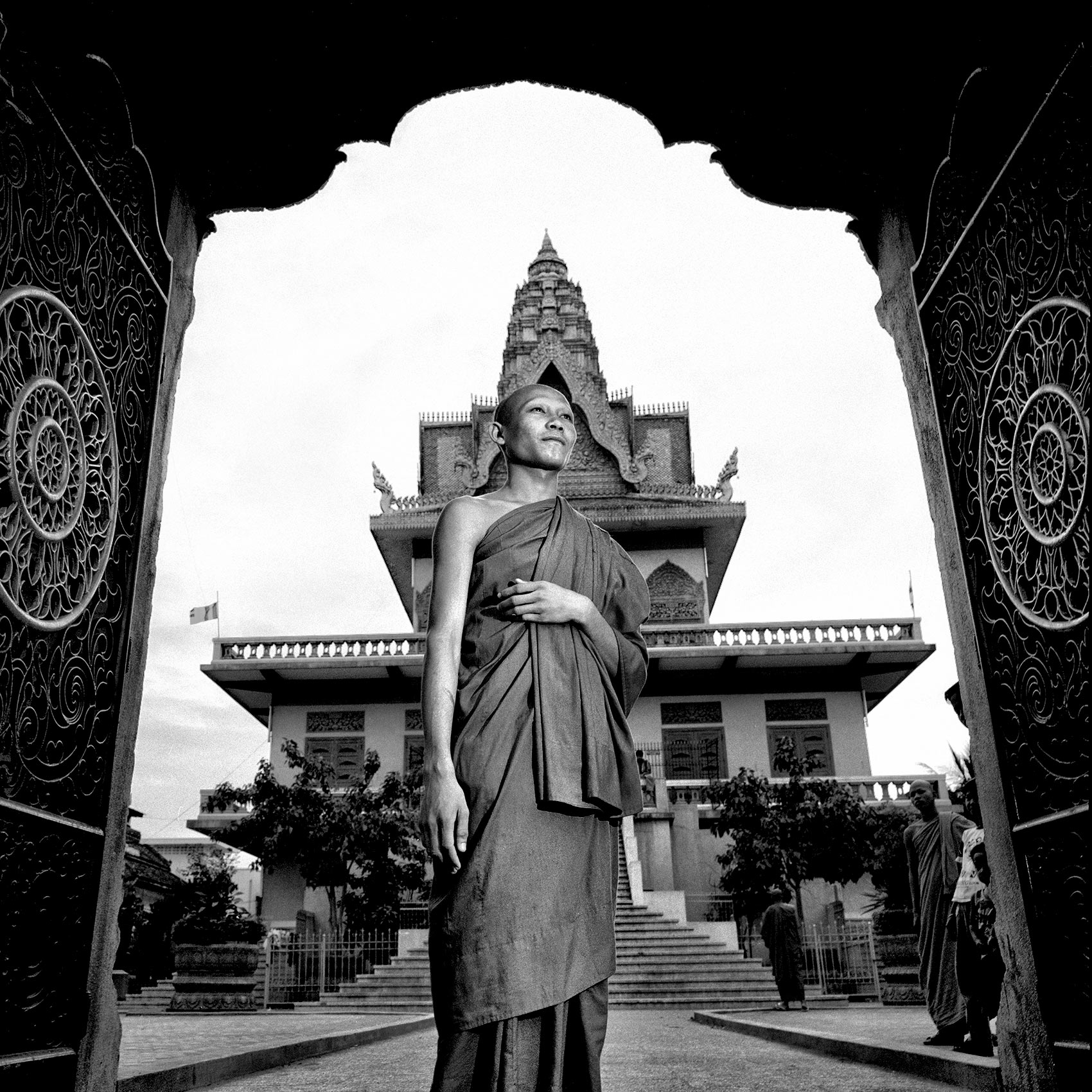 a-cambodian-monk-poses-for-a-photo-outside-the-main-palace-in-angkor-wat