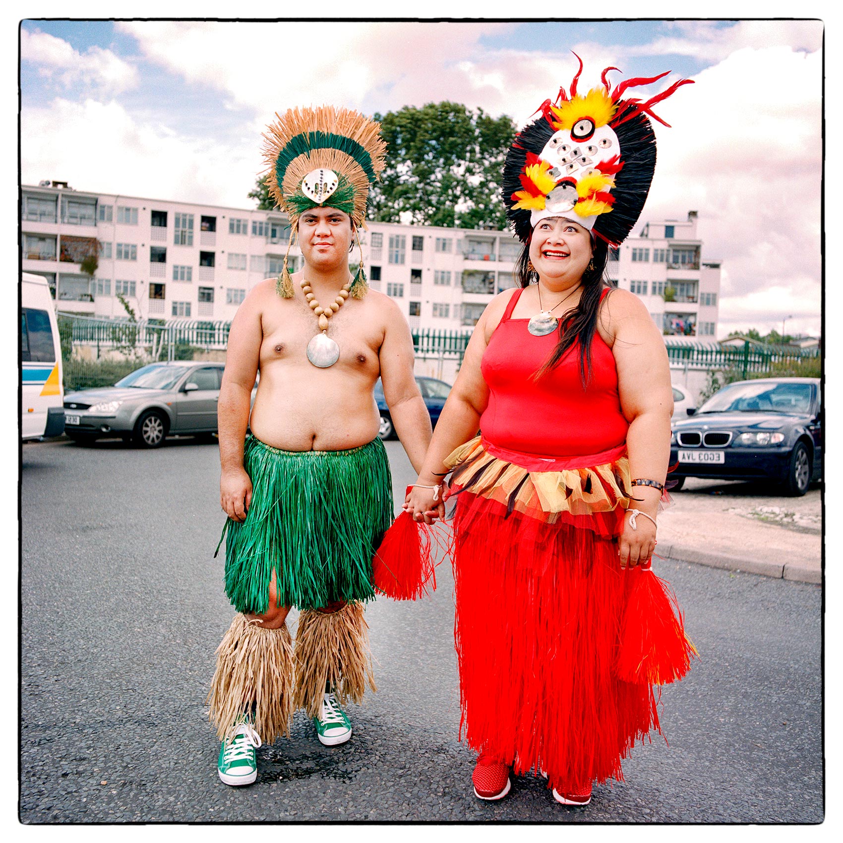 a-couple-dressed-in-south-pacific-dress-pose-for-a-photo-during-london-englands-carnival-parade-in-notting-hill