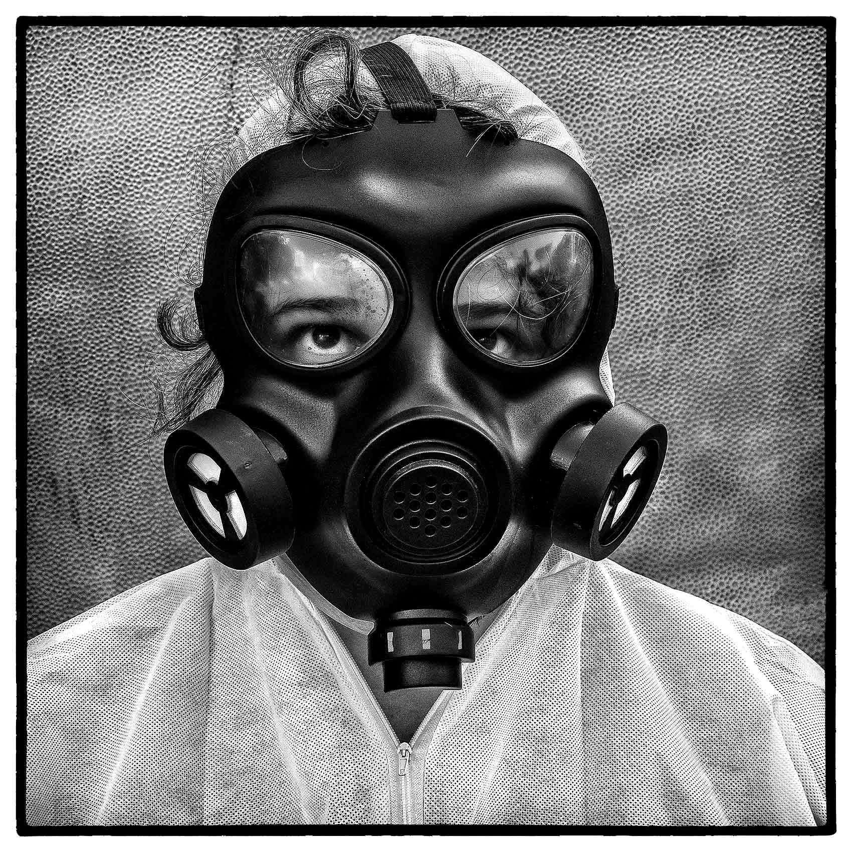 a woman sweats in full ppe as she wears a gas mask in toronto during the covid-19 pandemic 
