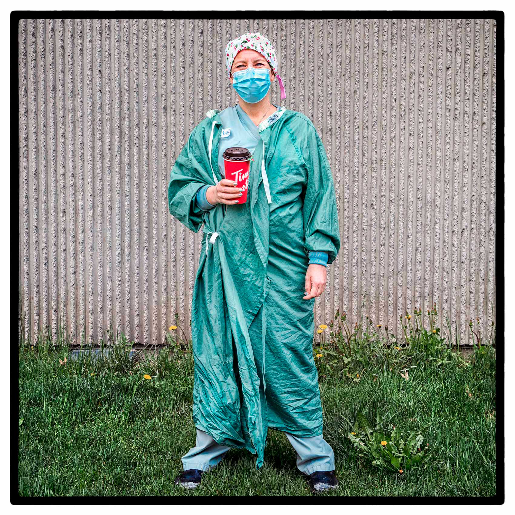 a toronto nurse wearing her gown and  ppe during the pandemic outside saint michaels hospital