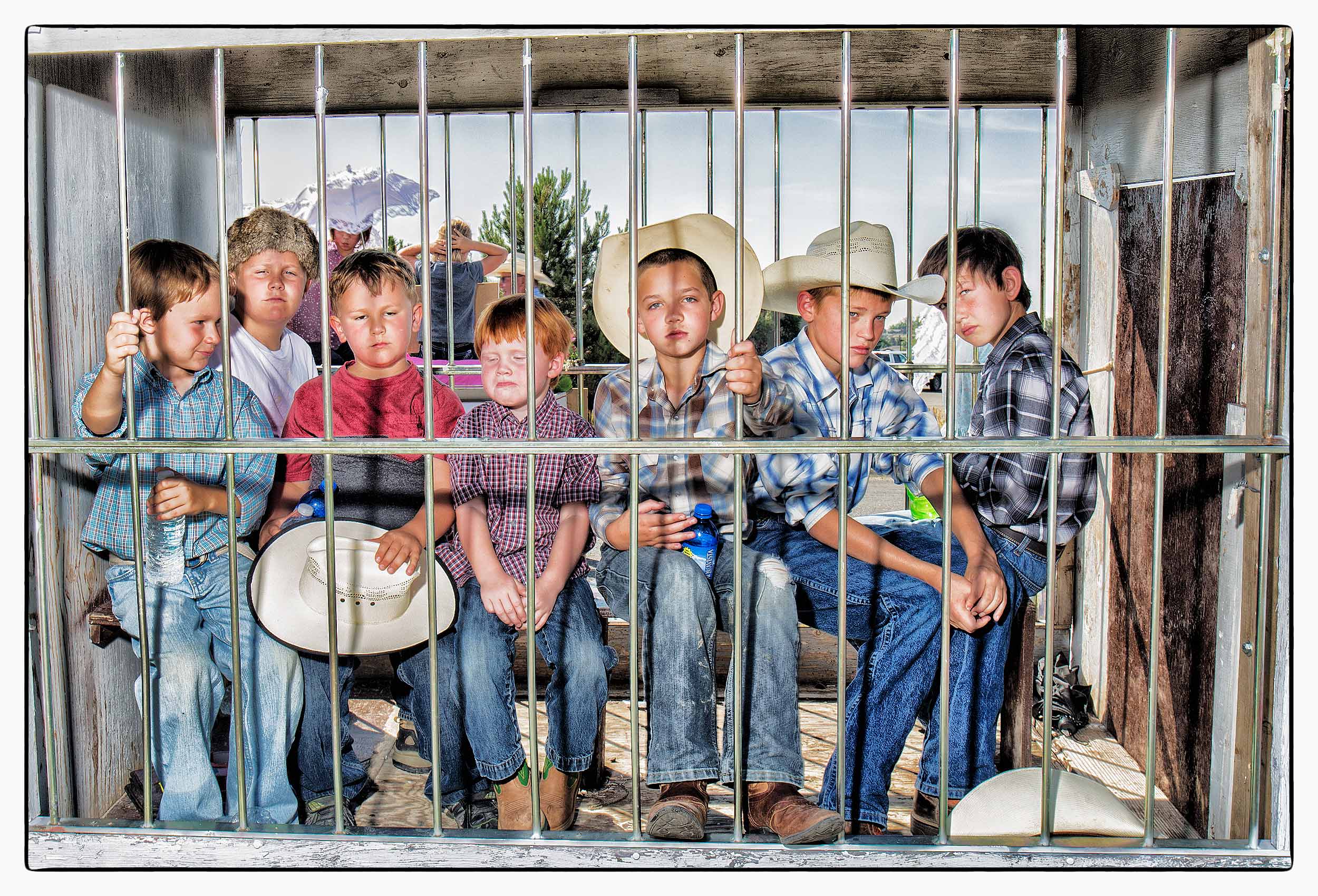 a-group-of-children-are-unhappy-as-they-are-held-in-a-mock-prison-on-a-float-during-the-fourth-of-july-celebrations-in-cody-wyoming