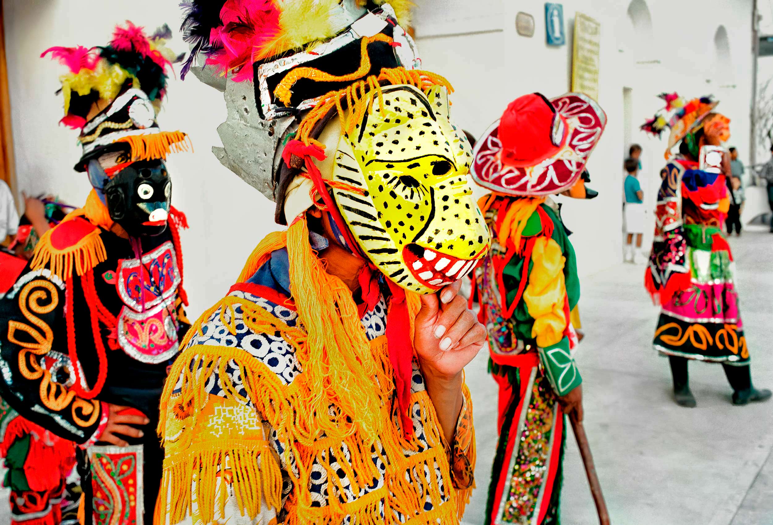 a-group-of-men-wear-masks-and-costumes-during-a-festival-in-flores-guatemala
