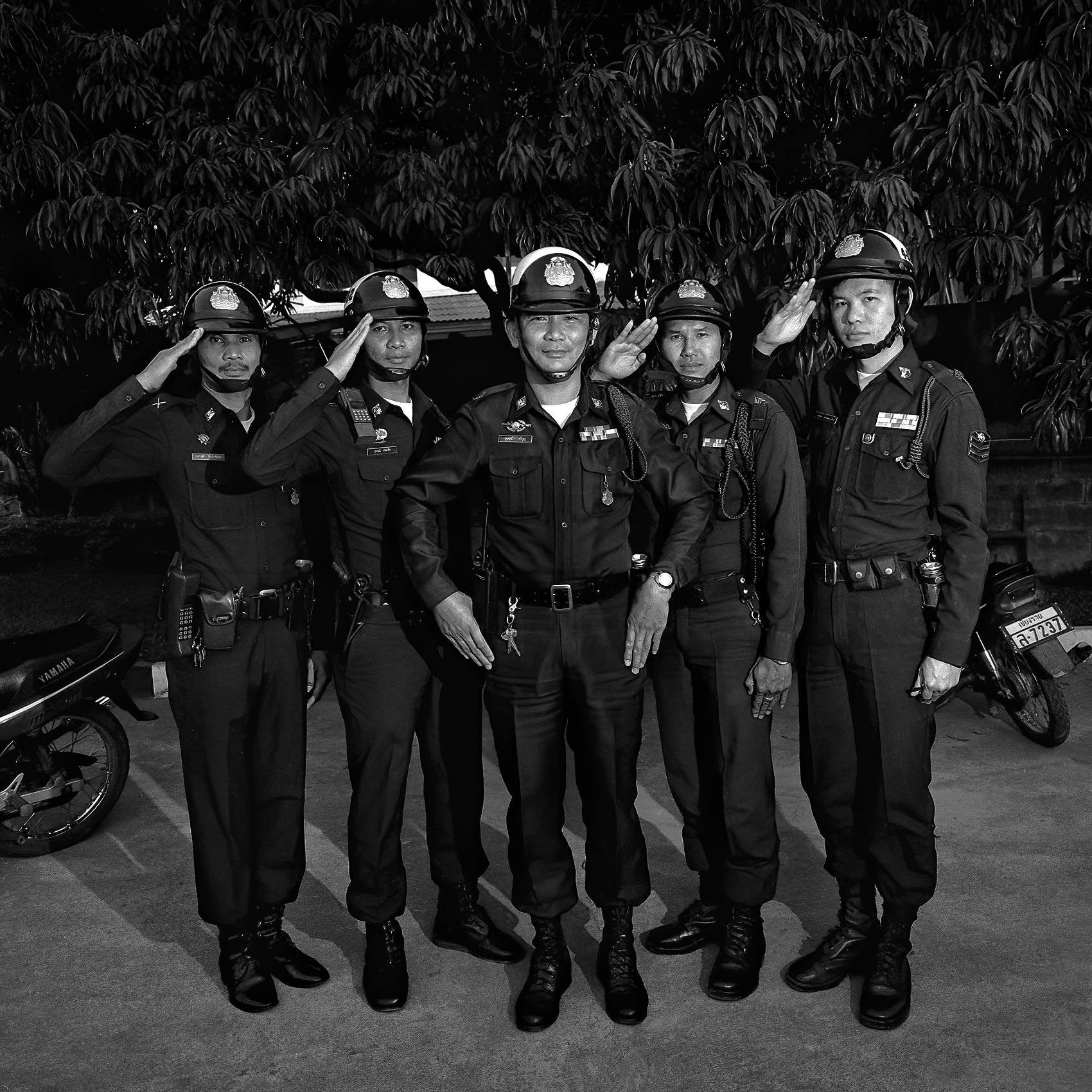 a-group-of-thai-police-officers-salute-while-posing-for-a-photo-in-bangkok