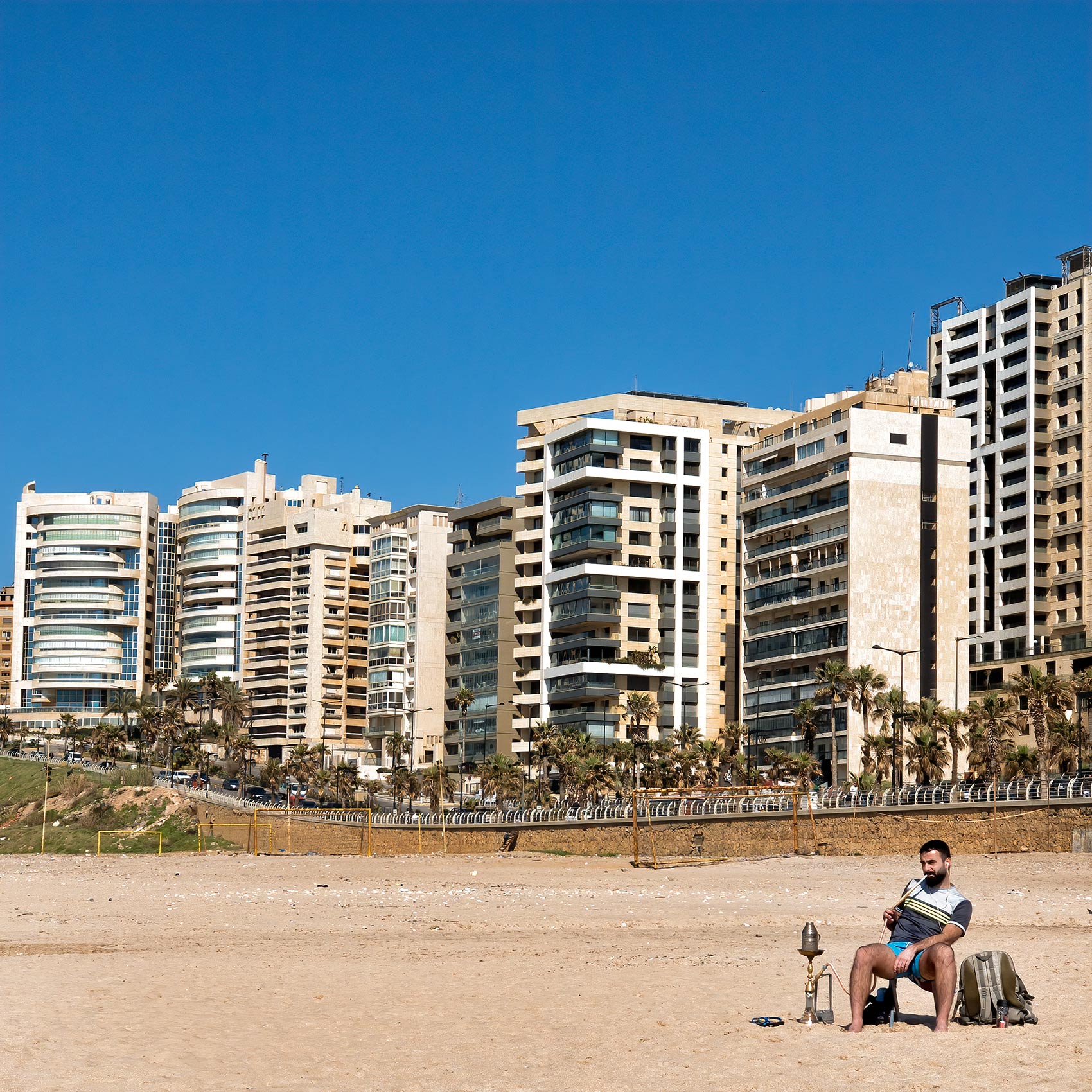 a-lebanese-man-smokes-his-shisha-pipe-while-sitting-on-a-beach-in-beirut-lebanon