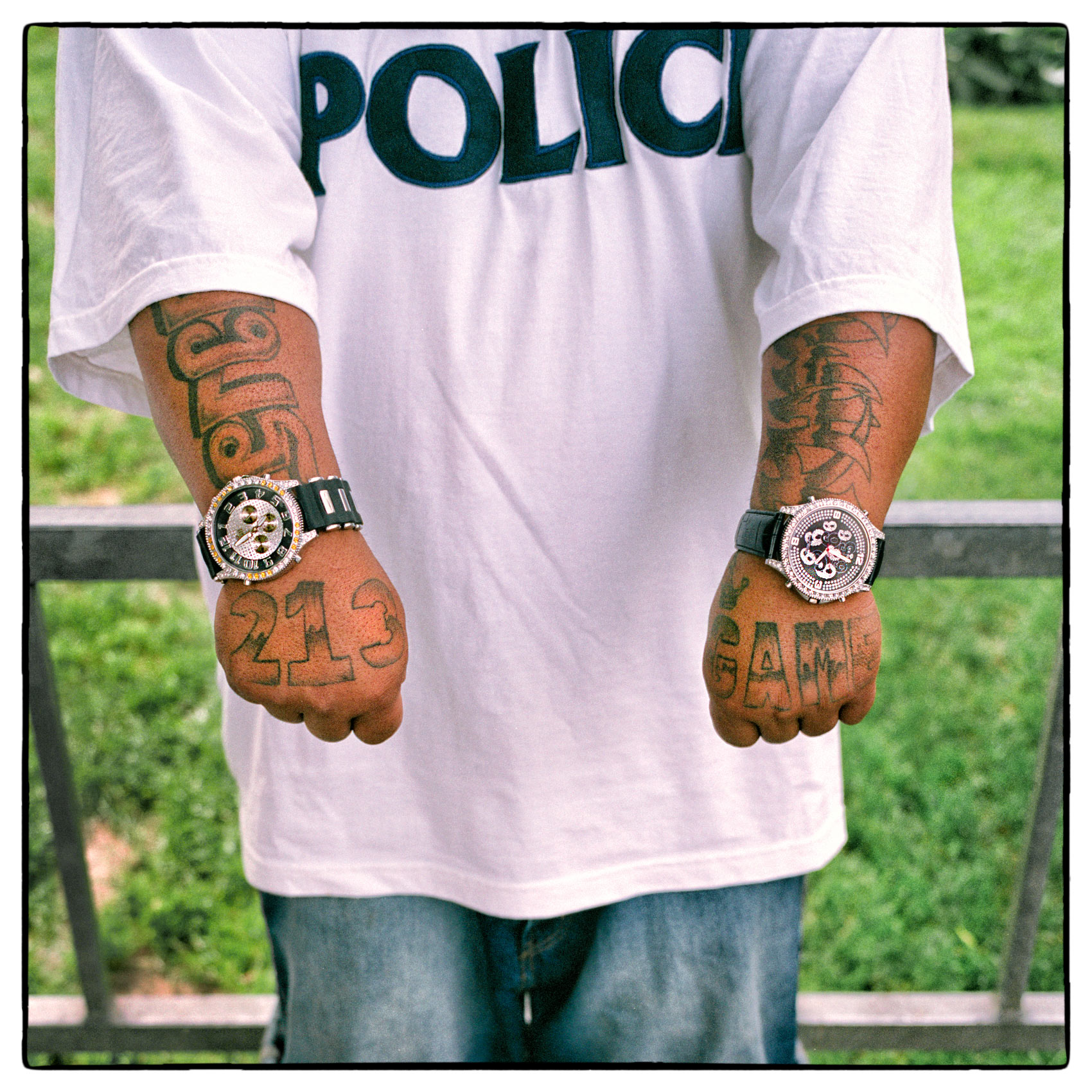 a-los-angeles-gang-member-shows-off-his-tatoos-and-watches-on-both-wrists-border