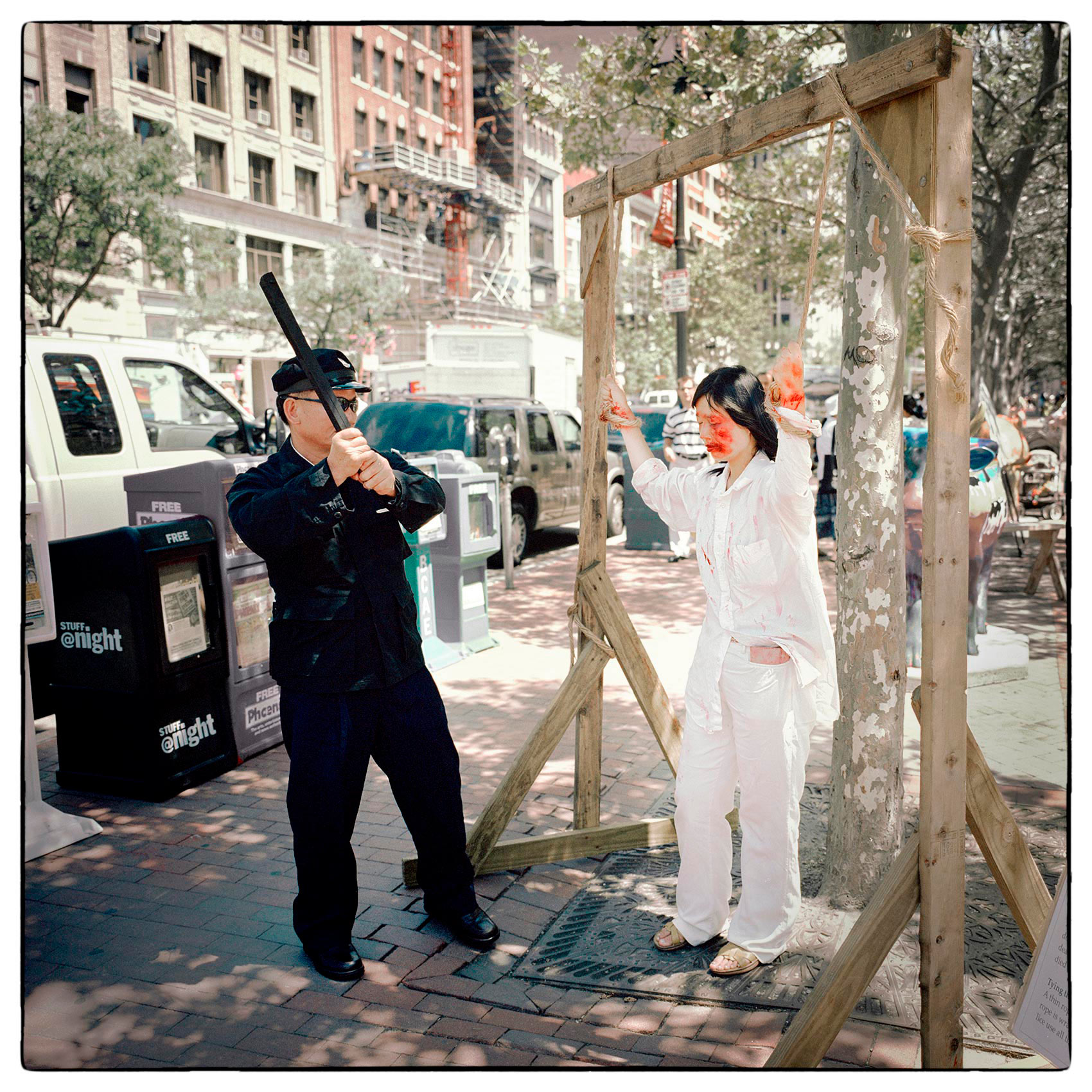 a-man-dressed-as-a-chines-policeman-pretends-to-torture-a-chinese-prisoner-during-a-protest-against-the-country-in-boston-massachusetts