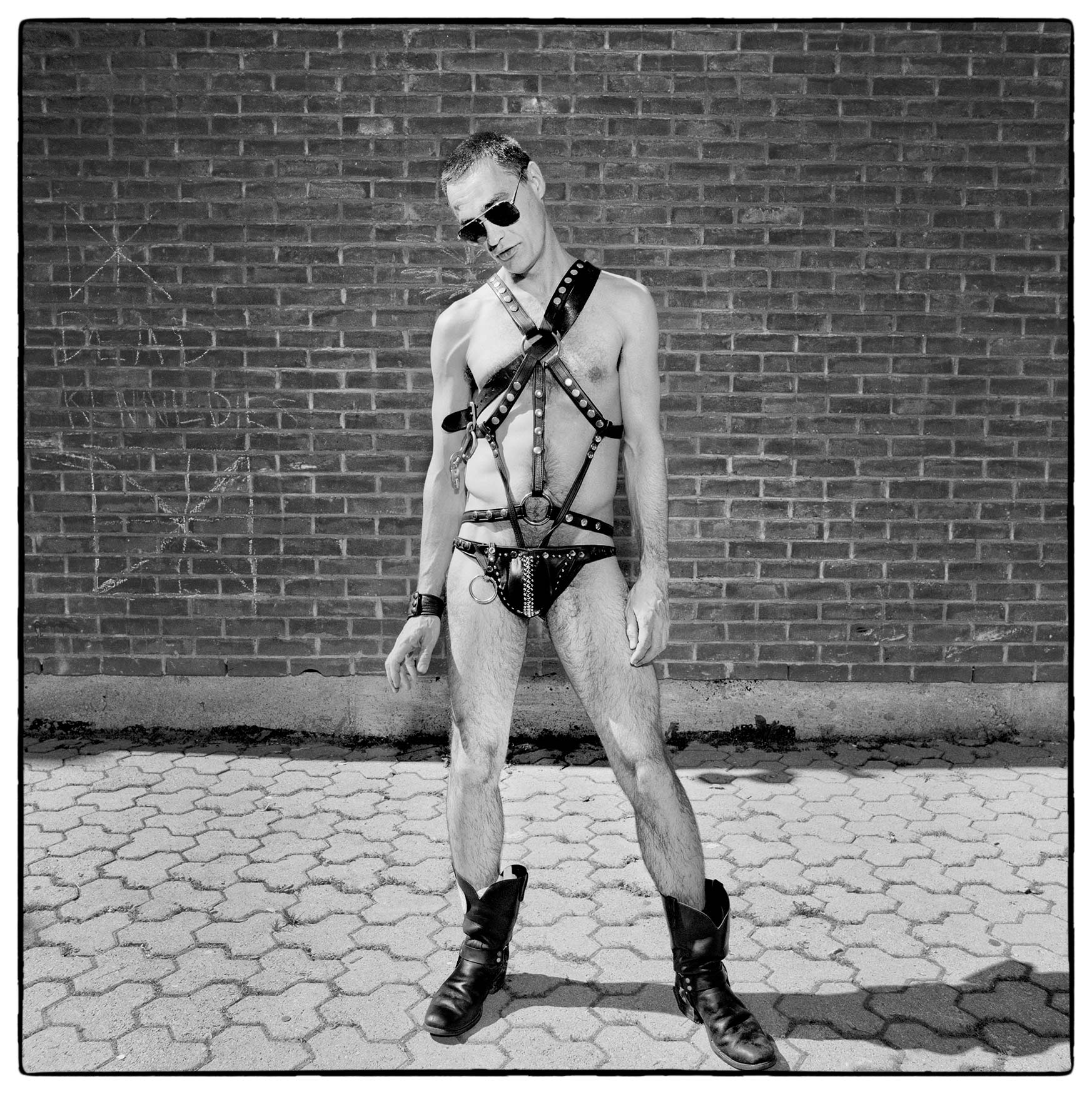 a-man-dressed-in-a-skimpy-leather-outfit-poses-for-a-photo-at-toronto-gay-pride