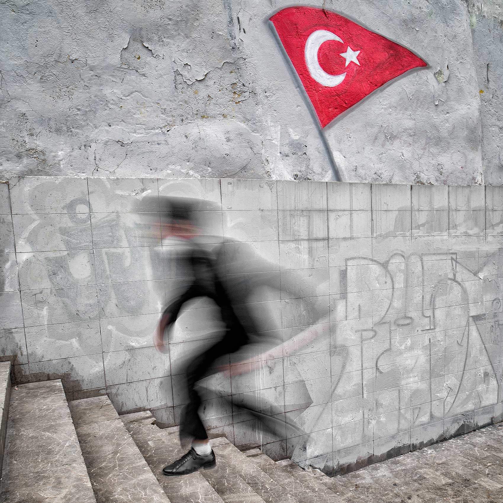 a-man-is-blurred-as-he-runs-up-the-steps-from-an-istanbul-subway