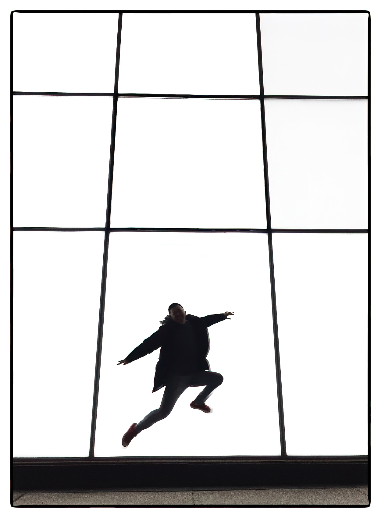 chang-jiang-is-silhouetted-as-he-jumps-up-in-front-of-a-white-retail-sign-in-dundas-square-toronto