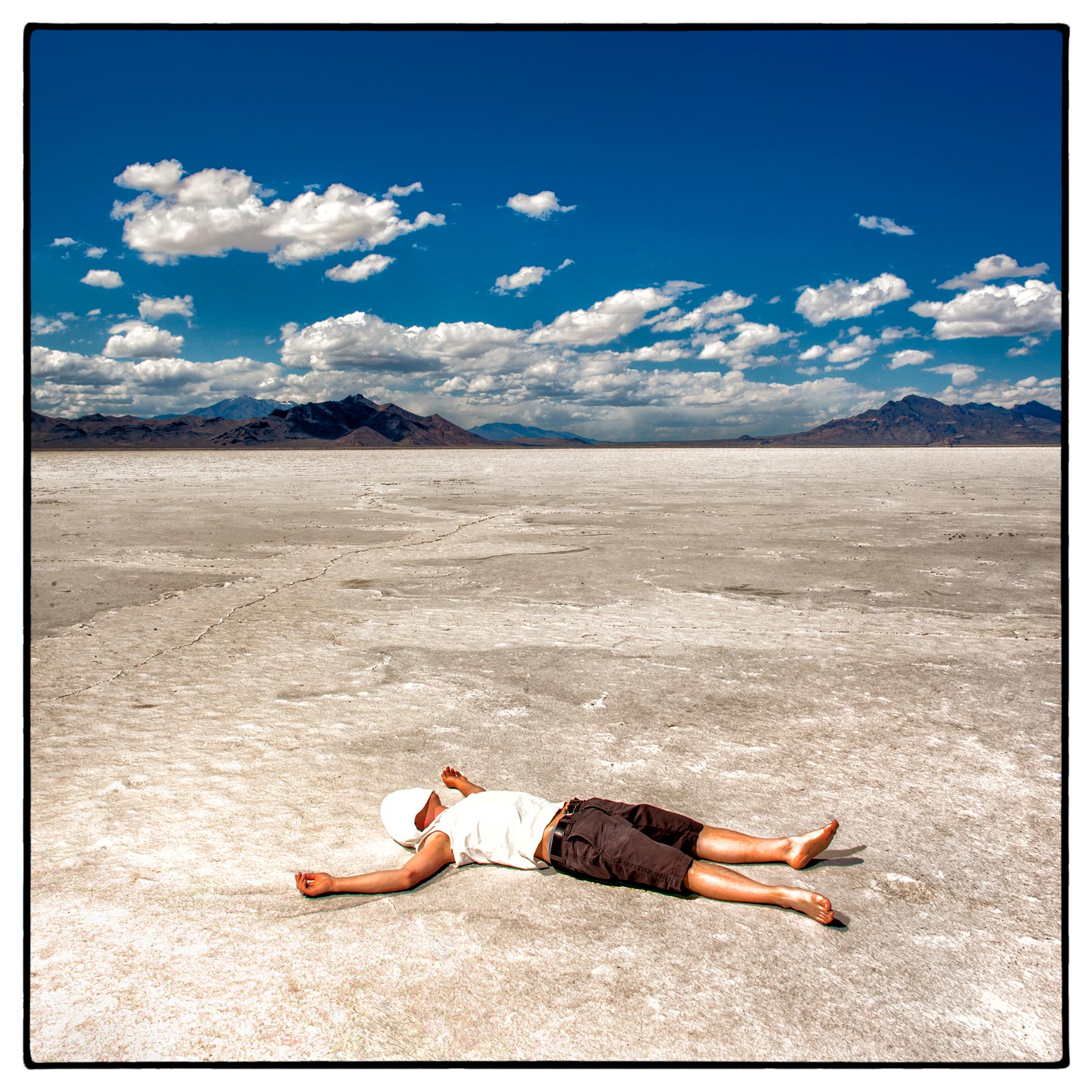 a-man-lays-on-the-bed-of-the-bonneville-salt-flats-outside-of-salt-lake-city-utah