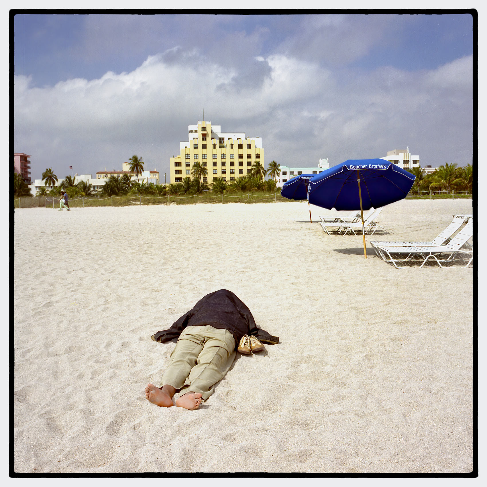 a-man-looks-dead-as-he-lays-sleeping-on-miami-beach-covered-in-a-jacket