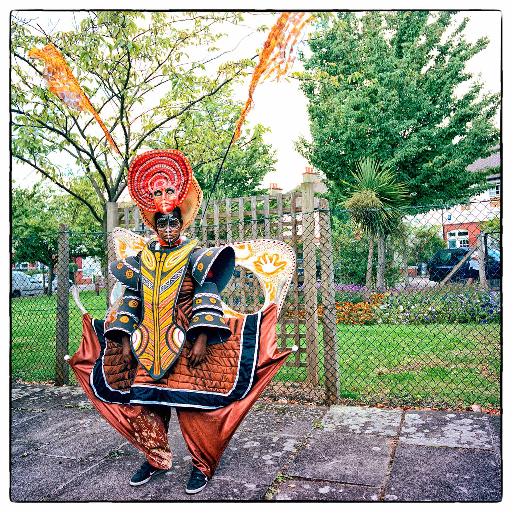 a-man-wearing-a-costume-poses-for-a-photo-in-londons-notting-hill-during-carnival