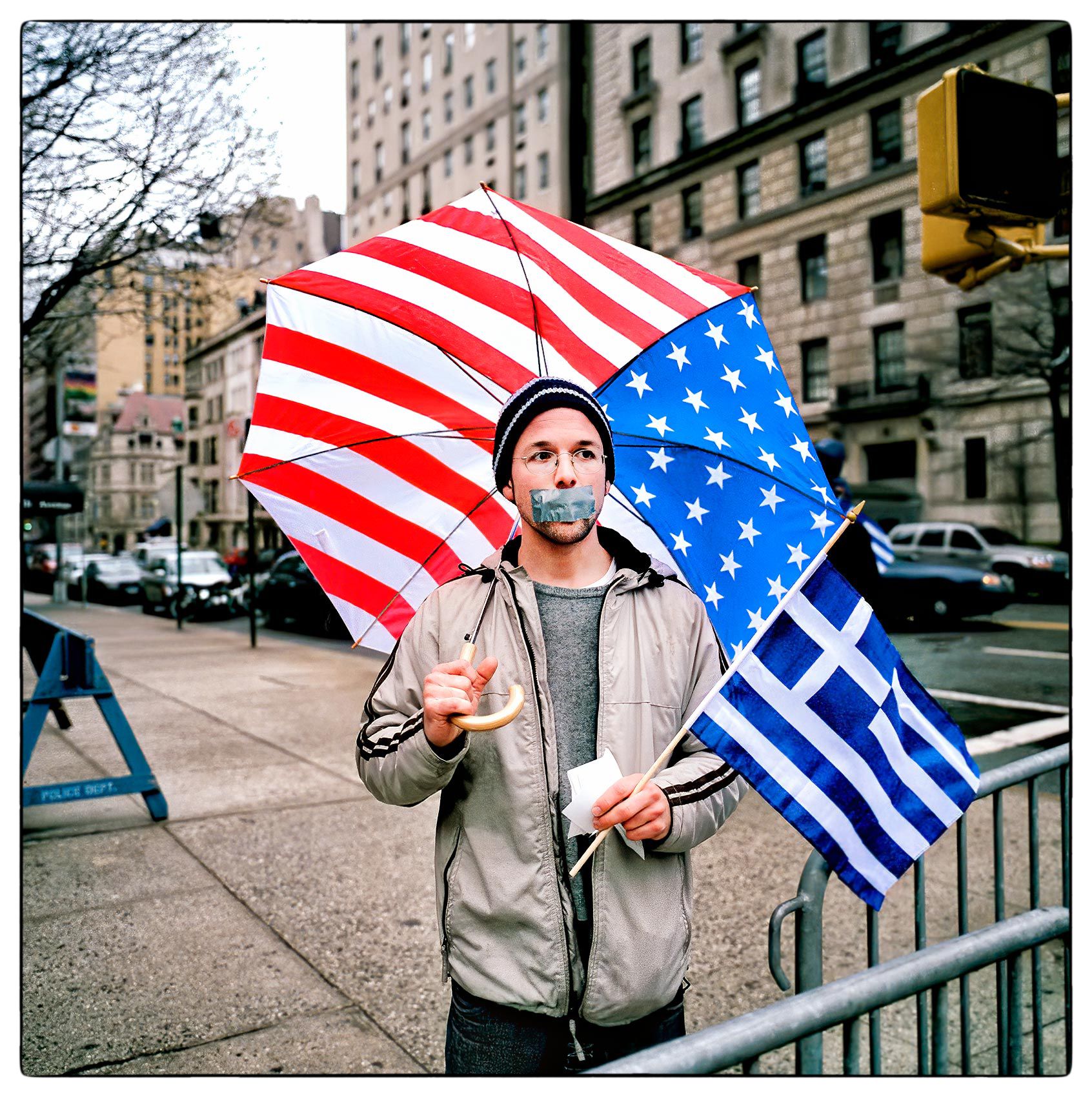 a-man-with-tape-over-his-mouth-stands-in-new-yorks-upper-east-side-after-a-demonstration