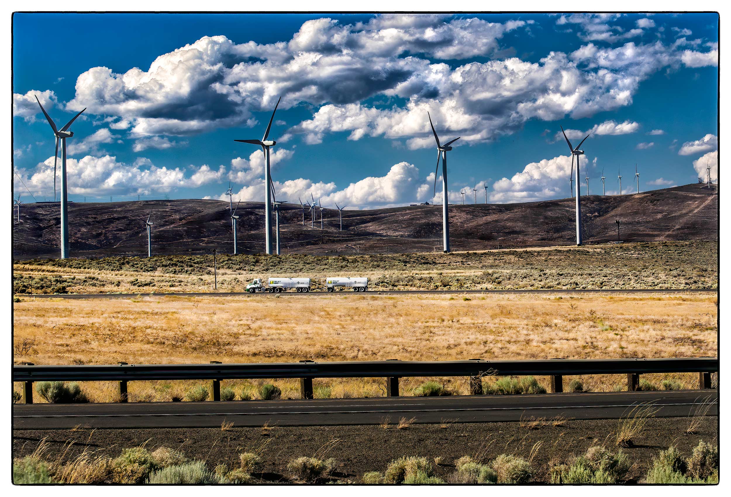 a-millky-way-truck-drives-past-puget-sound-engerys-wind-turbine-farm-in-rural-kittitas-county-washington-state
