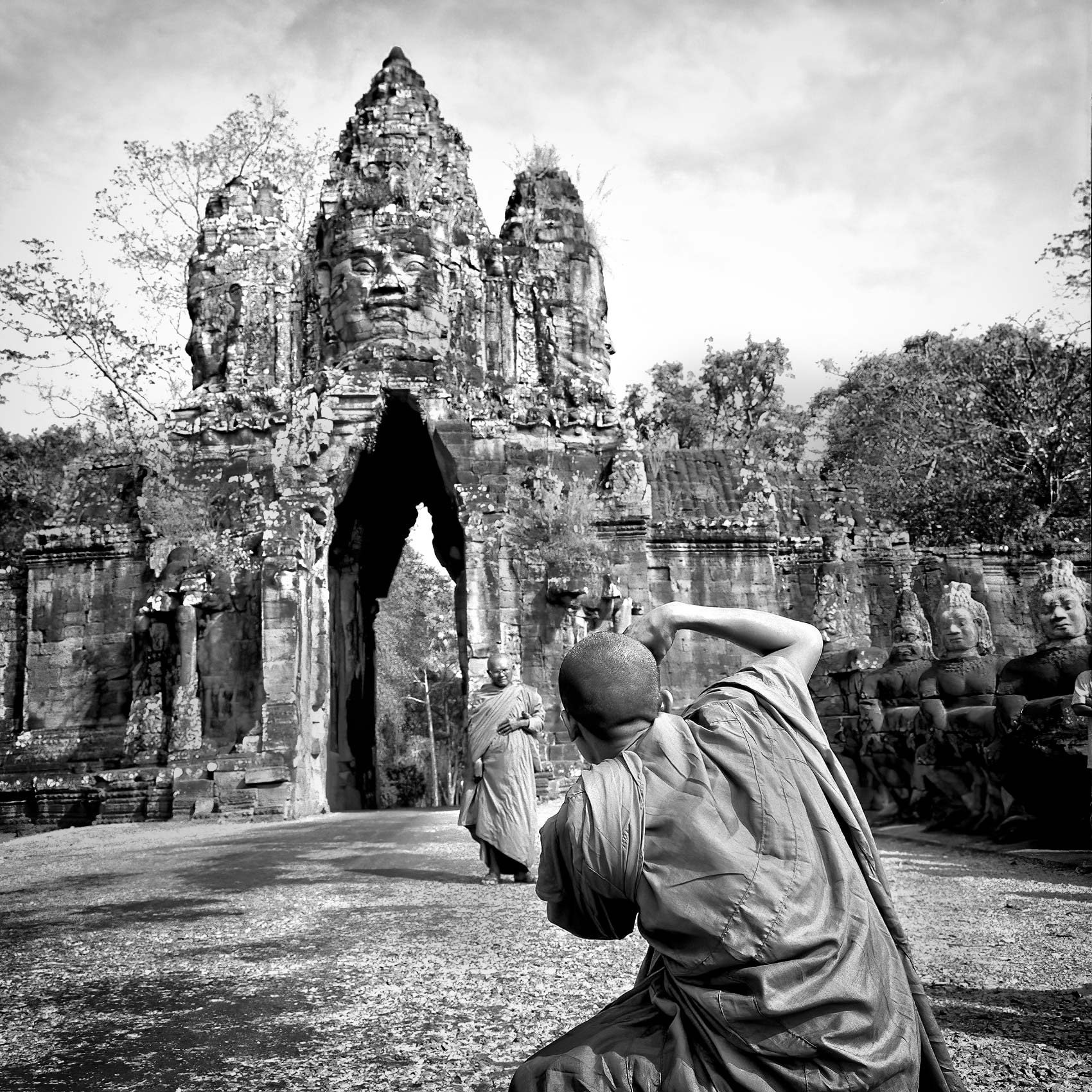 a-monk-takes-a-photo-of-his-friend-at-the-entrance-to-angkor-wat-cambodia