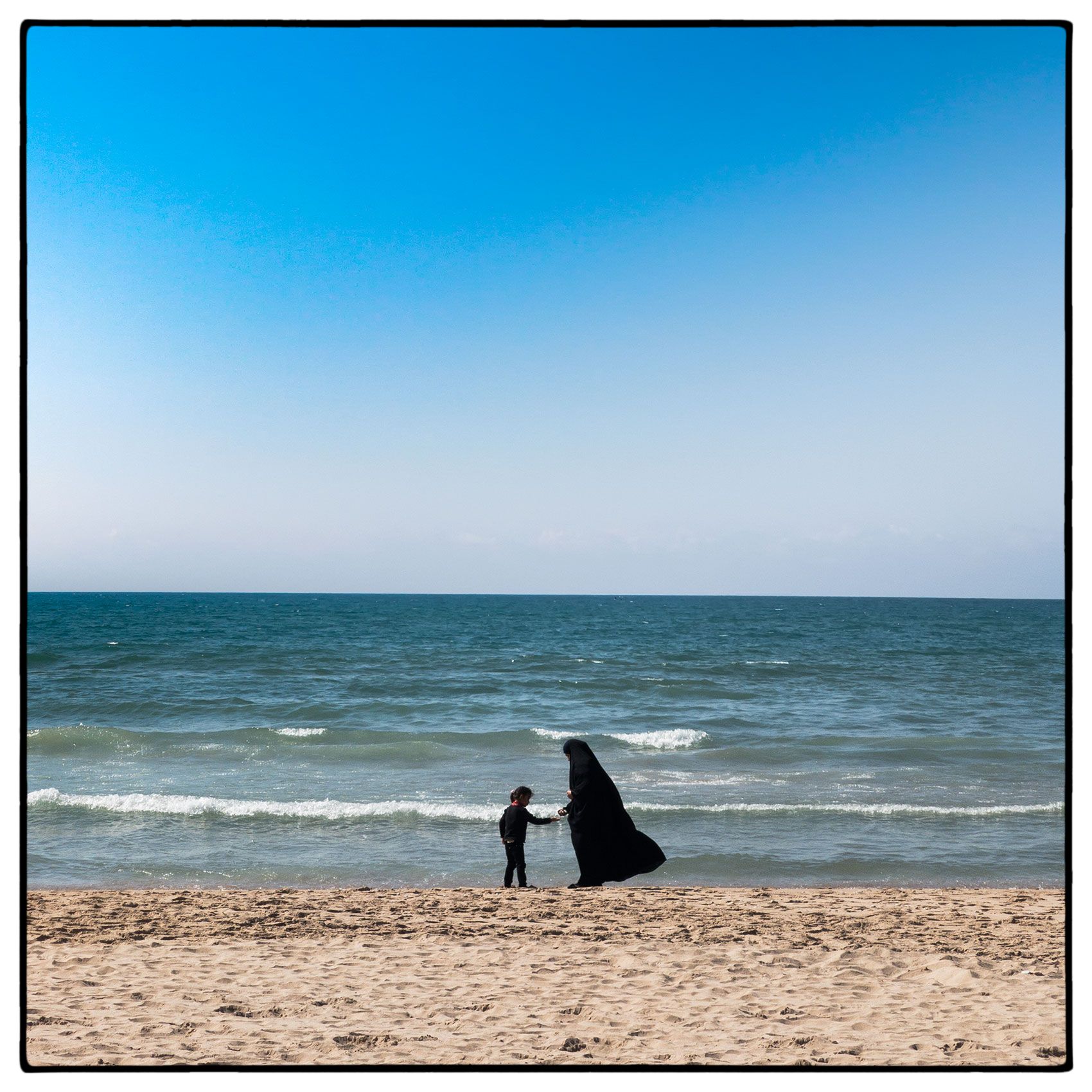 a-muslim-woman-in-a-burqa--with-her-daughter-on-the-beach-in-beirut-lebanon