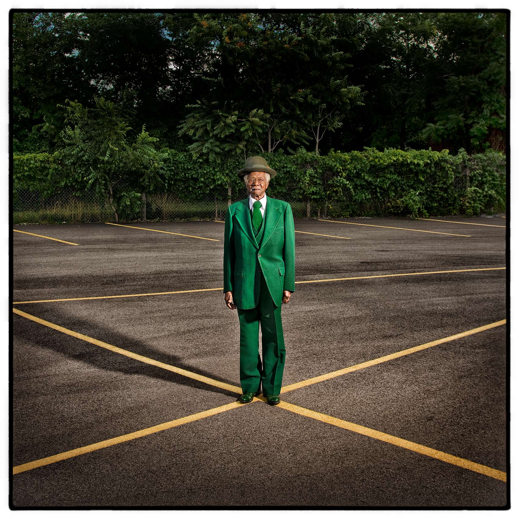 a-old-man-in-a-green-suit-in-a-buffalo-new-york-parking-lot