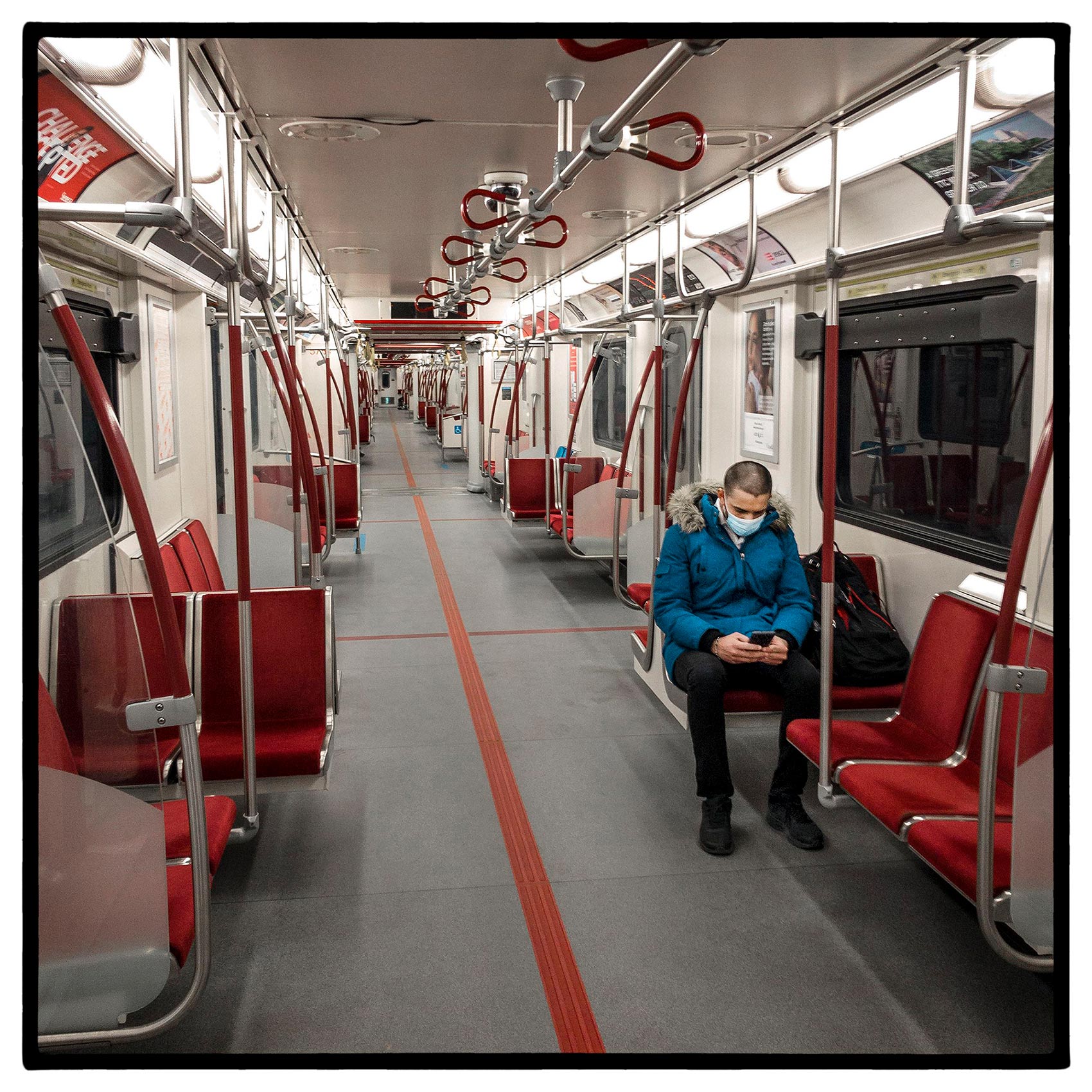 a man sits in an empty toronto subway car during the first wave of the pandemic