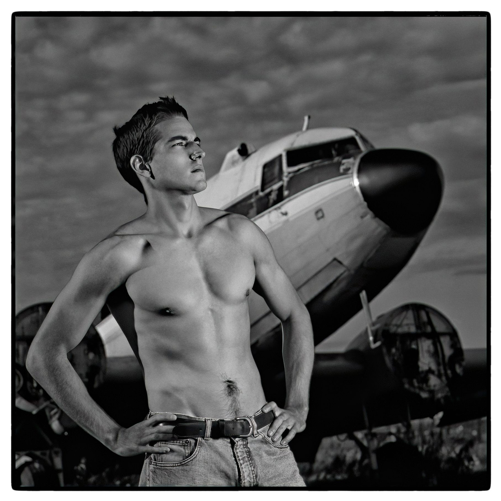 a-shirtless-male-model-poses-in-front-of-a-douglas-dc-3-at-carp-airport-in-ontario-canada