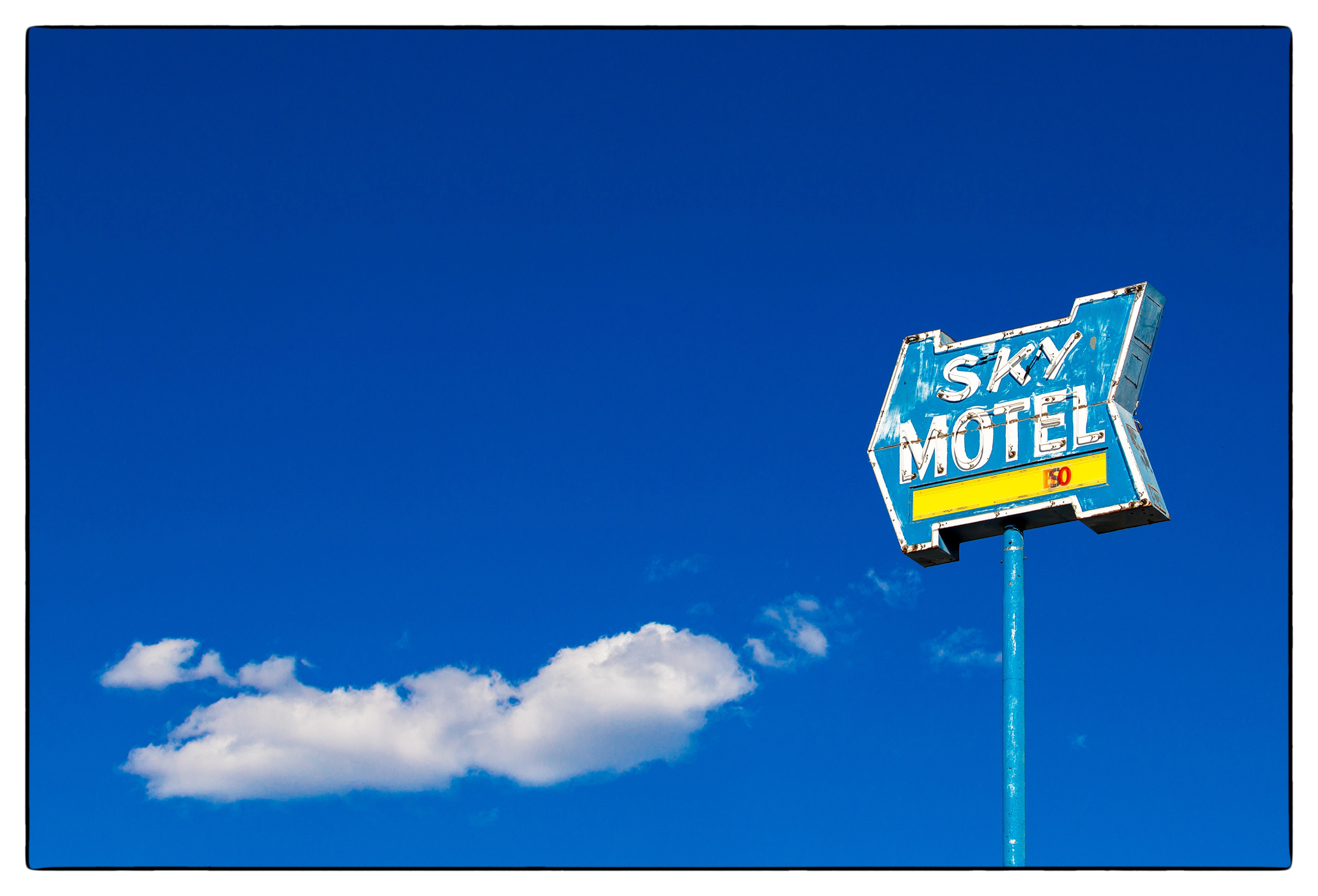 a-sky-motel-sign-against-a-deep-blue-sky-backdrop-in-south-dakota
