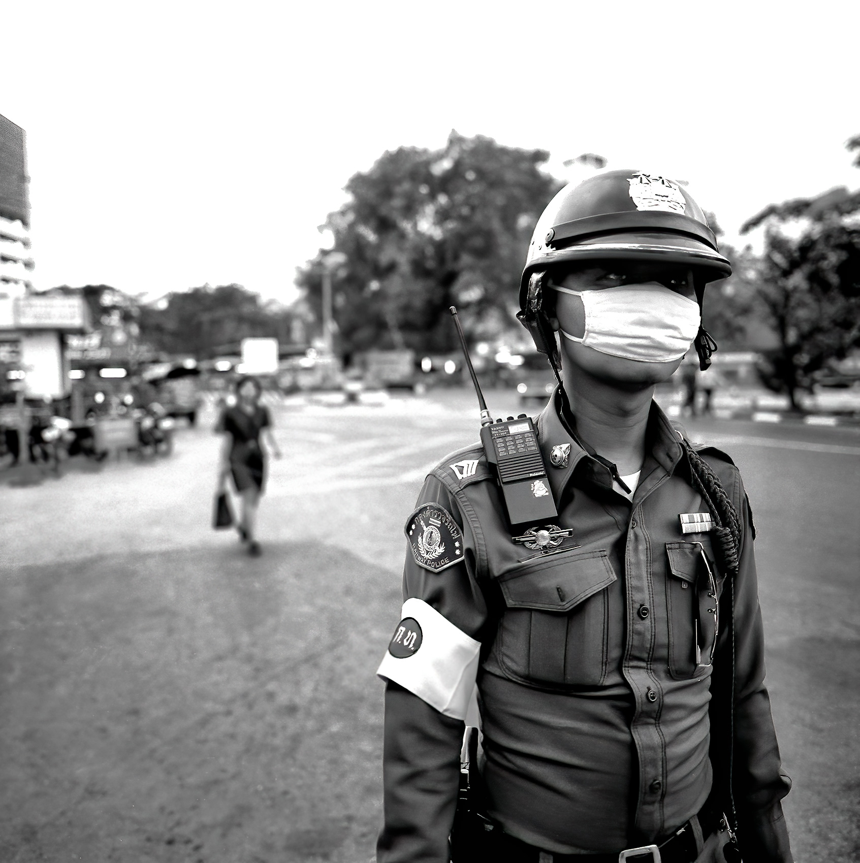 a-thai-police-officer-directs-traffic-while-wearing-a-face-mask-in-chang-mai-thailand