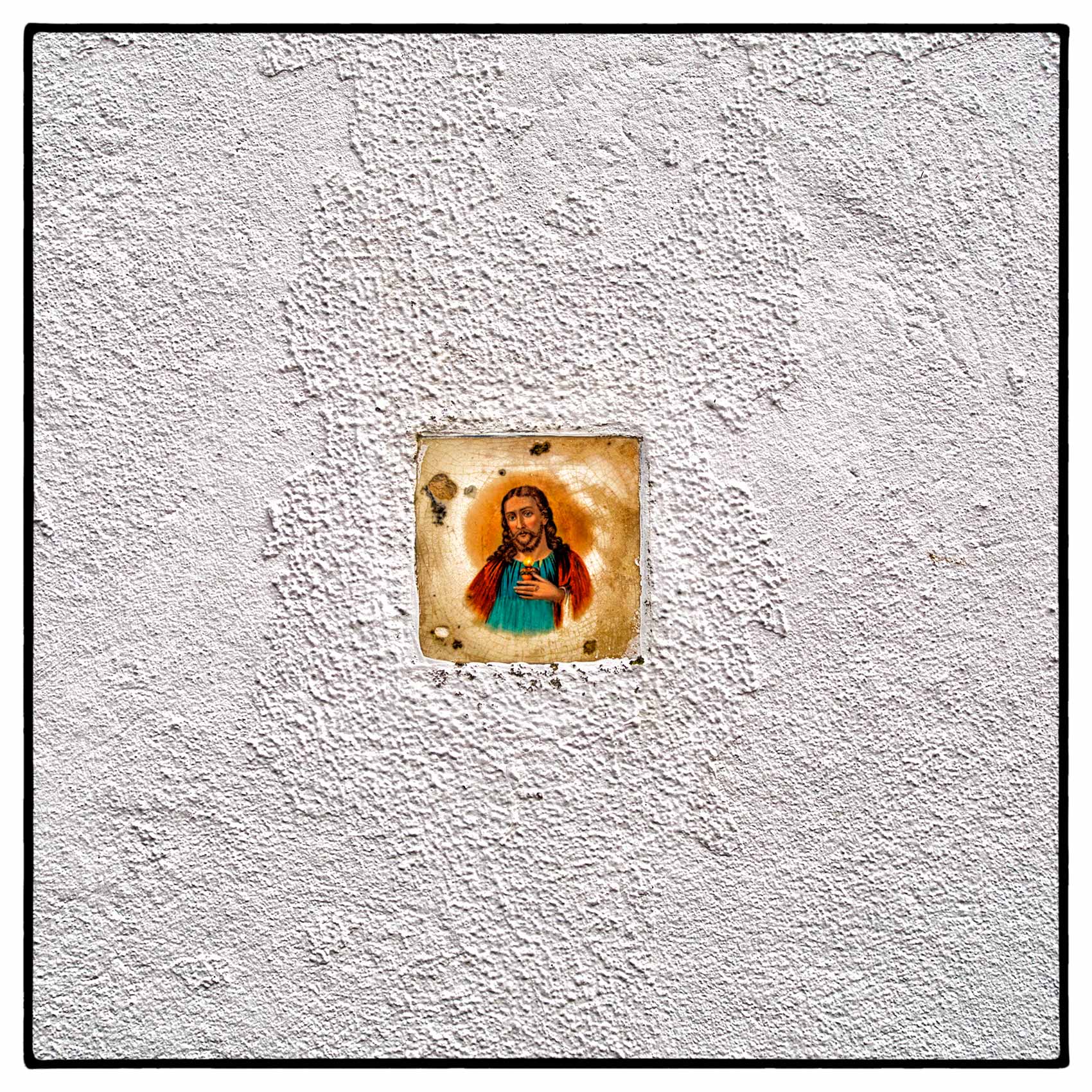 a-tile-with-the-face-of-jesus-christ-on-it-placed-in-a-wall-outside-a-home-in-portugal