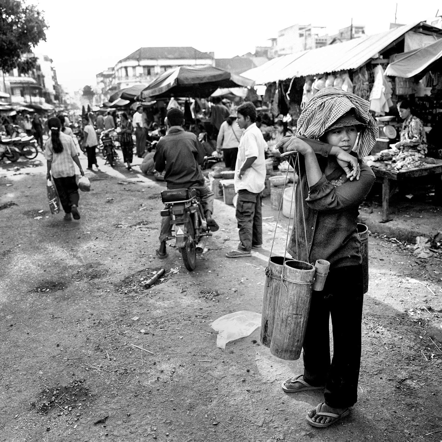 a-woman-in-an-outdoor-market-takes-a-break-from-selling-water-in-phnom-penh-cambodia
