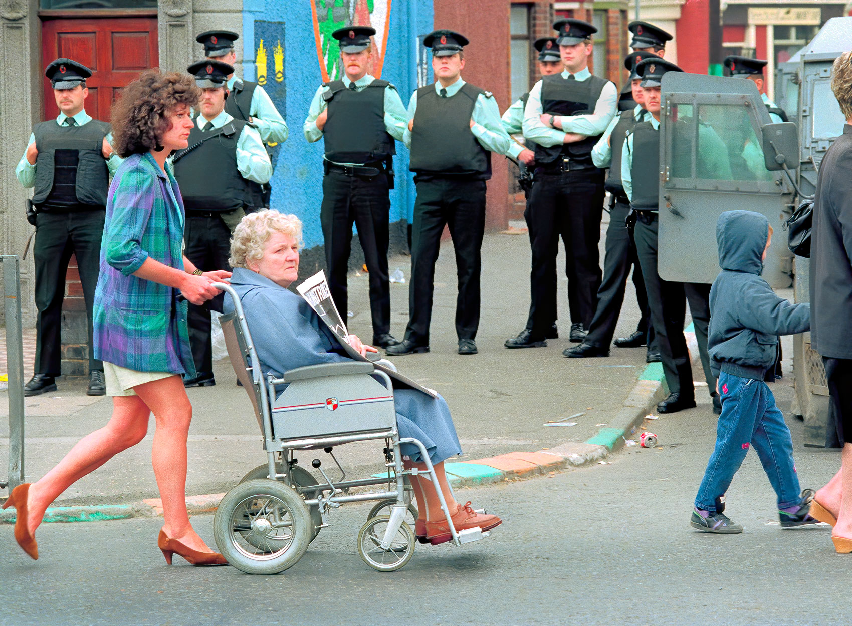 a-woman-pushes-her-mother-in-a-wheelchair-as-they-march-in-a-protest-past-the-royal-ulster-constabulary-in-catholic-west-belfast
