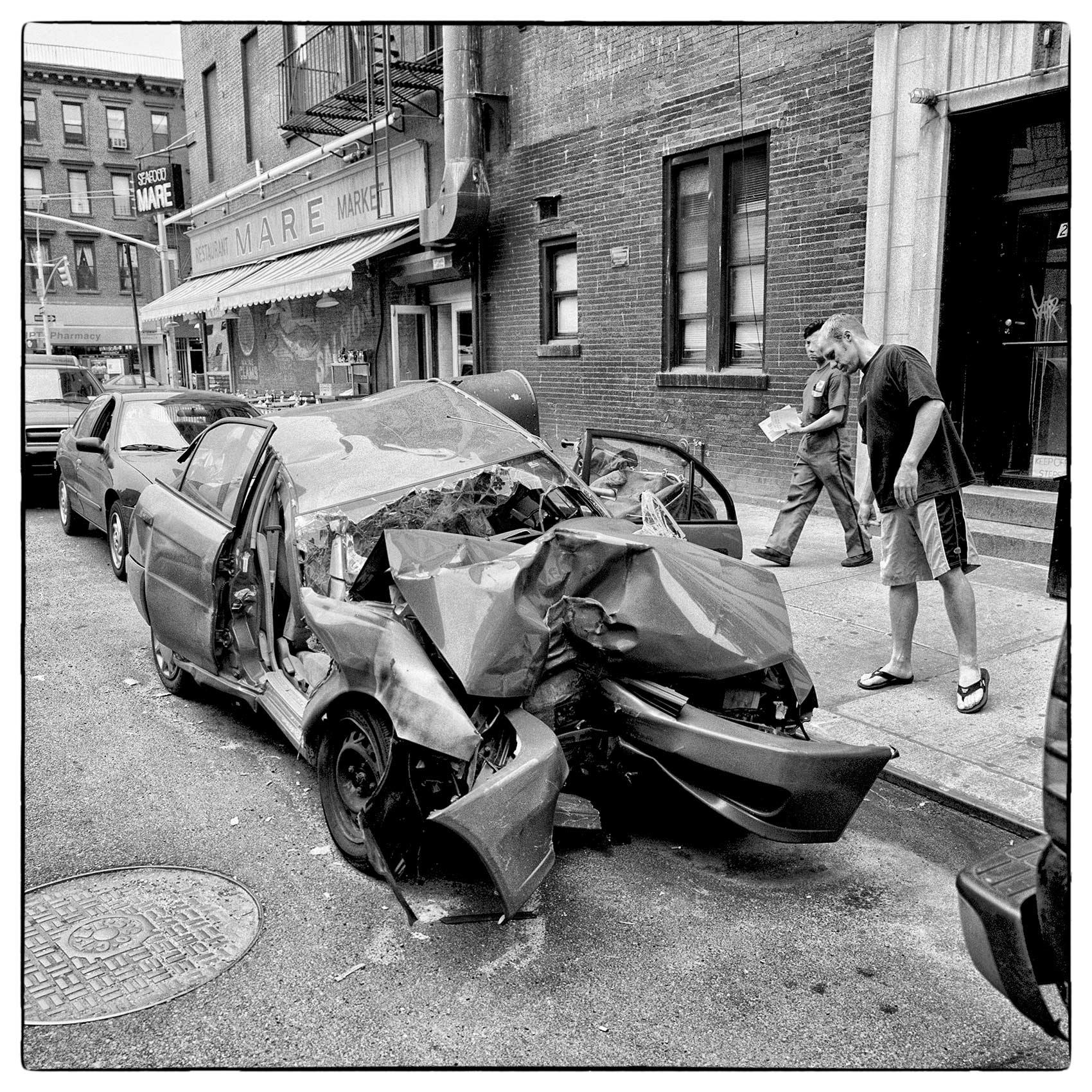a-wrecked-car-sits-in-a-parking-spot-in-downtown-manhattan