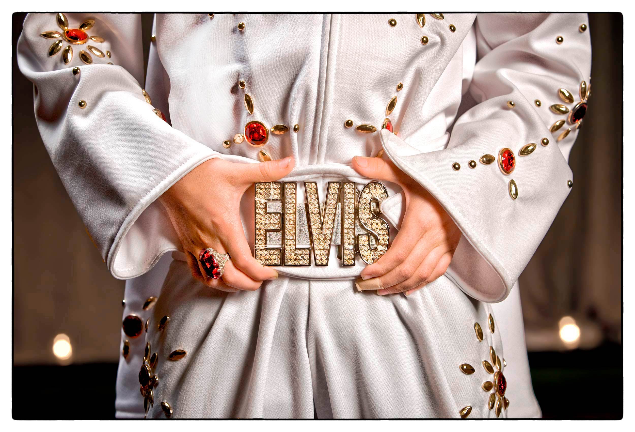 a-young-boy-dressed-as-elvis-presley-shows-off-his-large-silver-elvis-belt-buckle-at-a-celebrity-look-a-like-convention-in-las-vegas