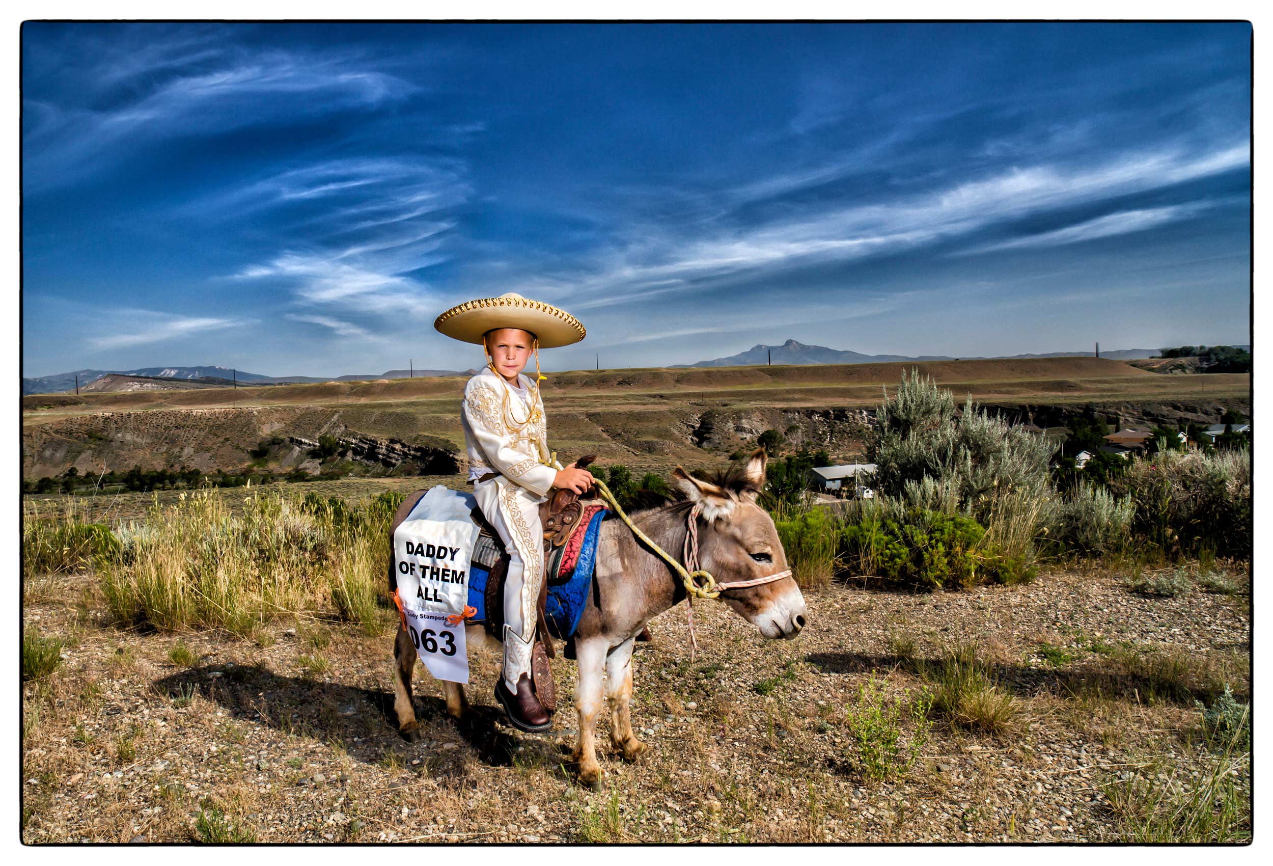 a-young-boy-dressed-in-mexican-attire-sits-on-a-donkey-during-rodeo-weekend-in-cody-wyoming