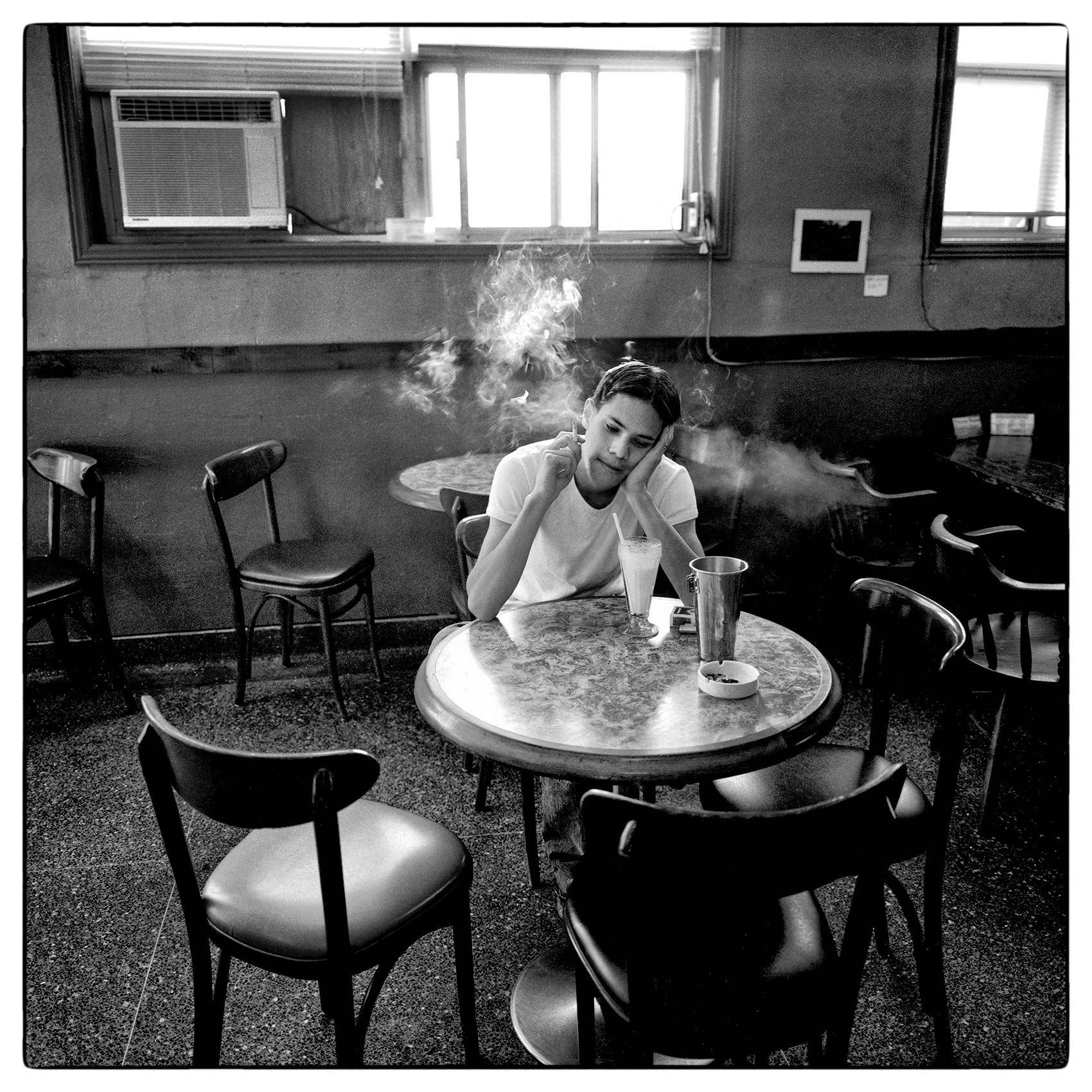 a-man-named-ebi-schonle-smokes-a-cigarette-in-a-munich-coffee-shop