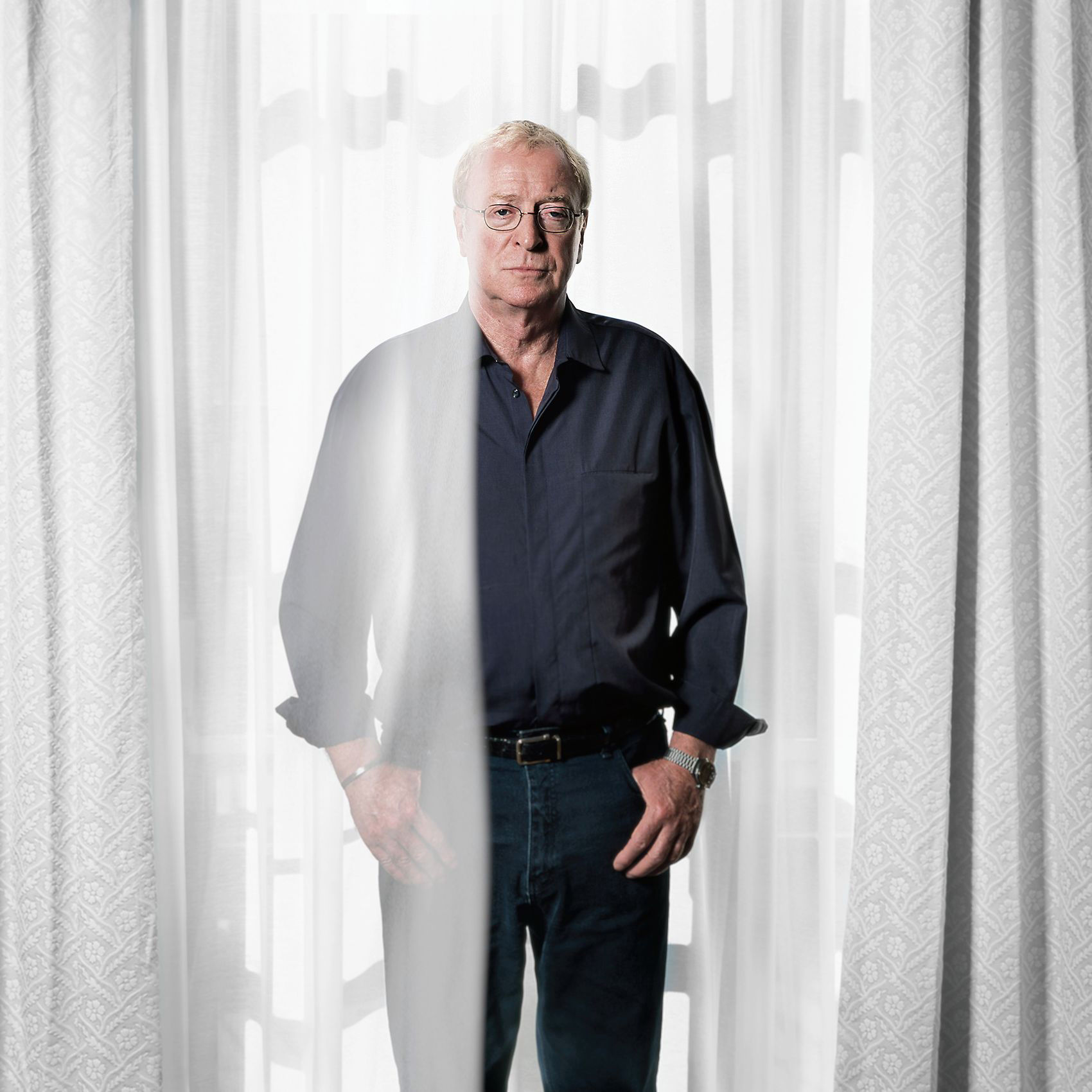 celebrity actor michael caine stands between two curtains for a photo at torontos tiff festival