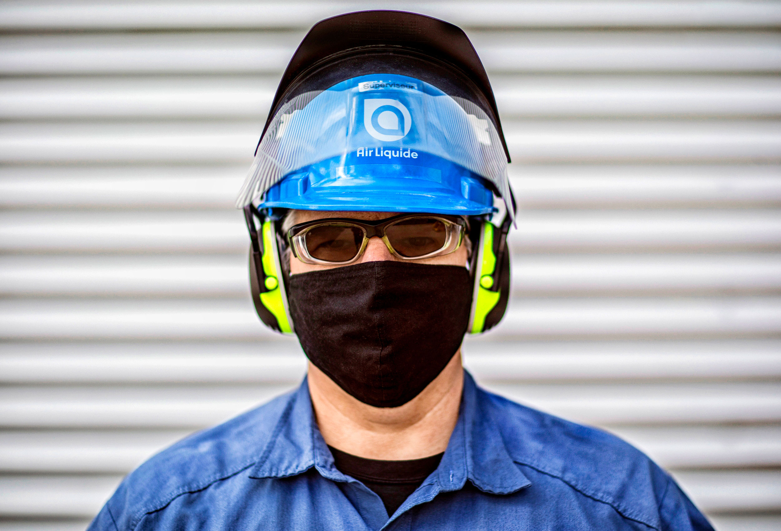 an industrial air liquide employee poses with his ppe for a corporate photo at their site in quebec canada
