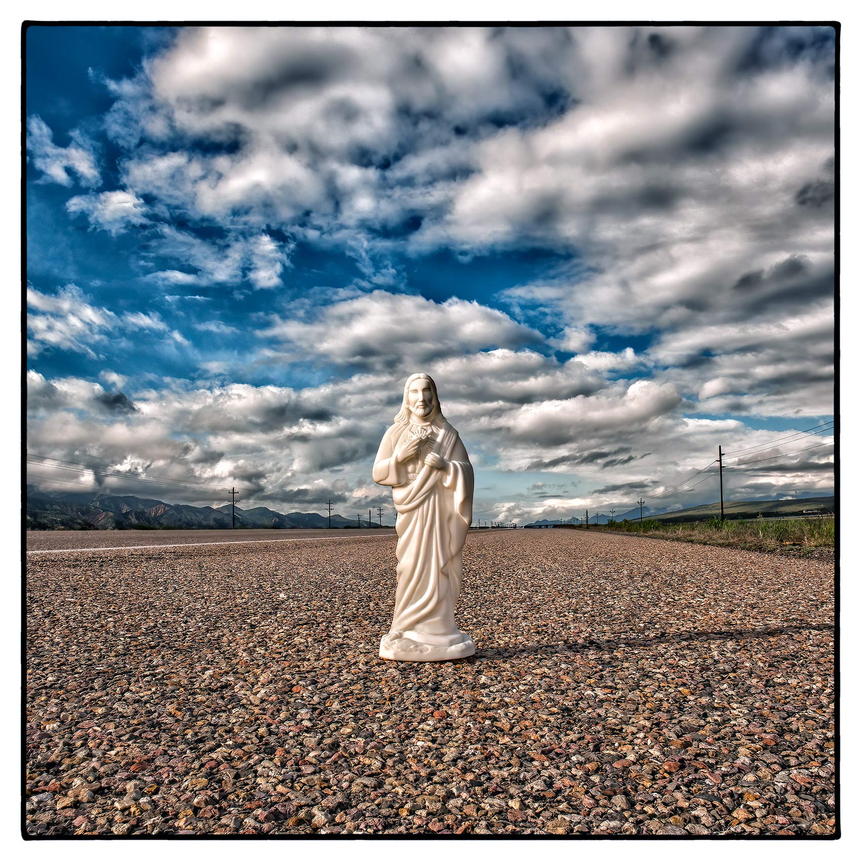 an-abandoned-statue-of-jesus-stands-by-the-side-of-a-highway-in-rural-nevada-usa