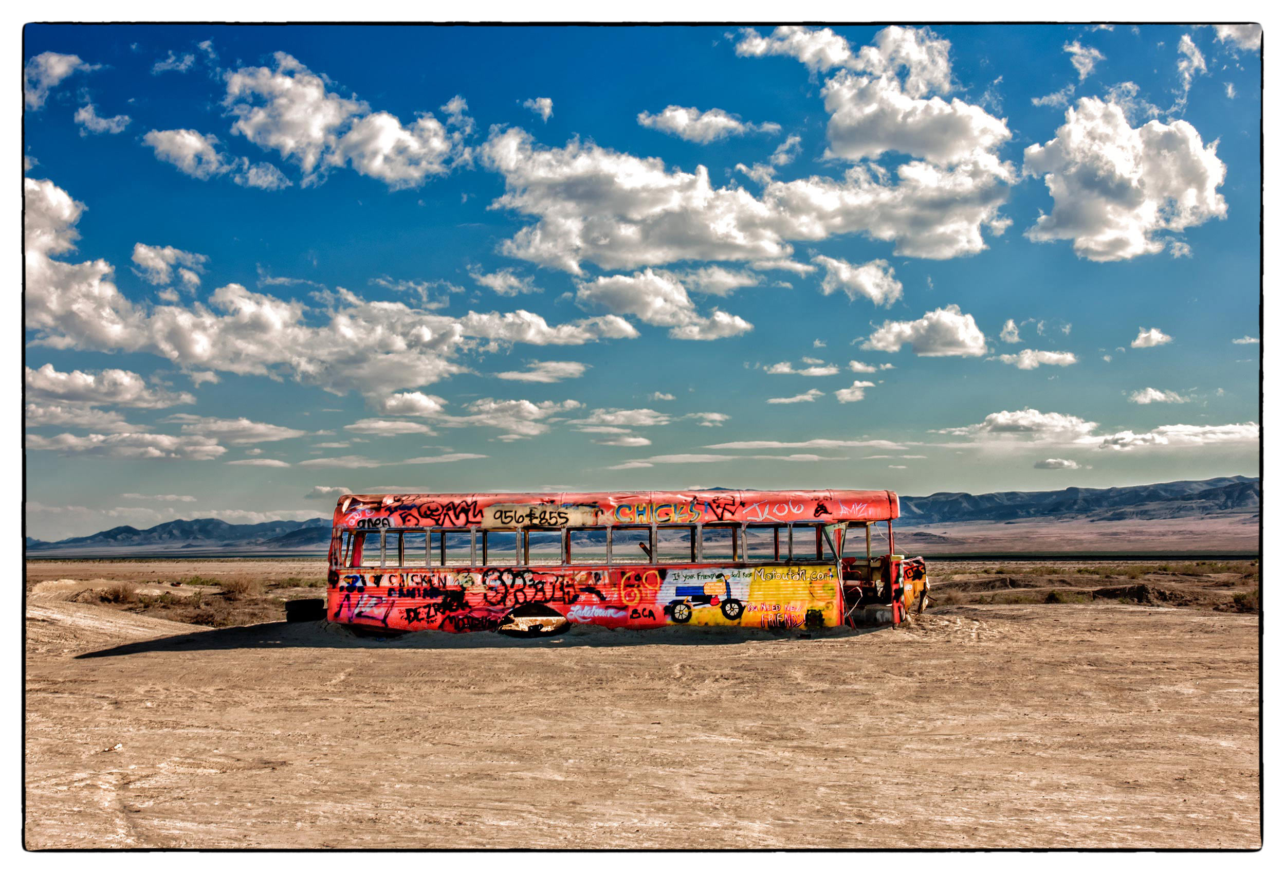 an-abandoned-yellow-school-bus-sits-in-the-middle-of-the-nevada-desert-outside-a-military-bombing-range