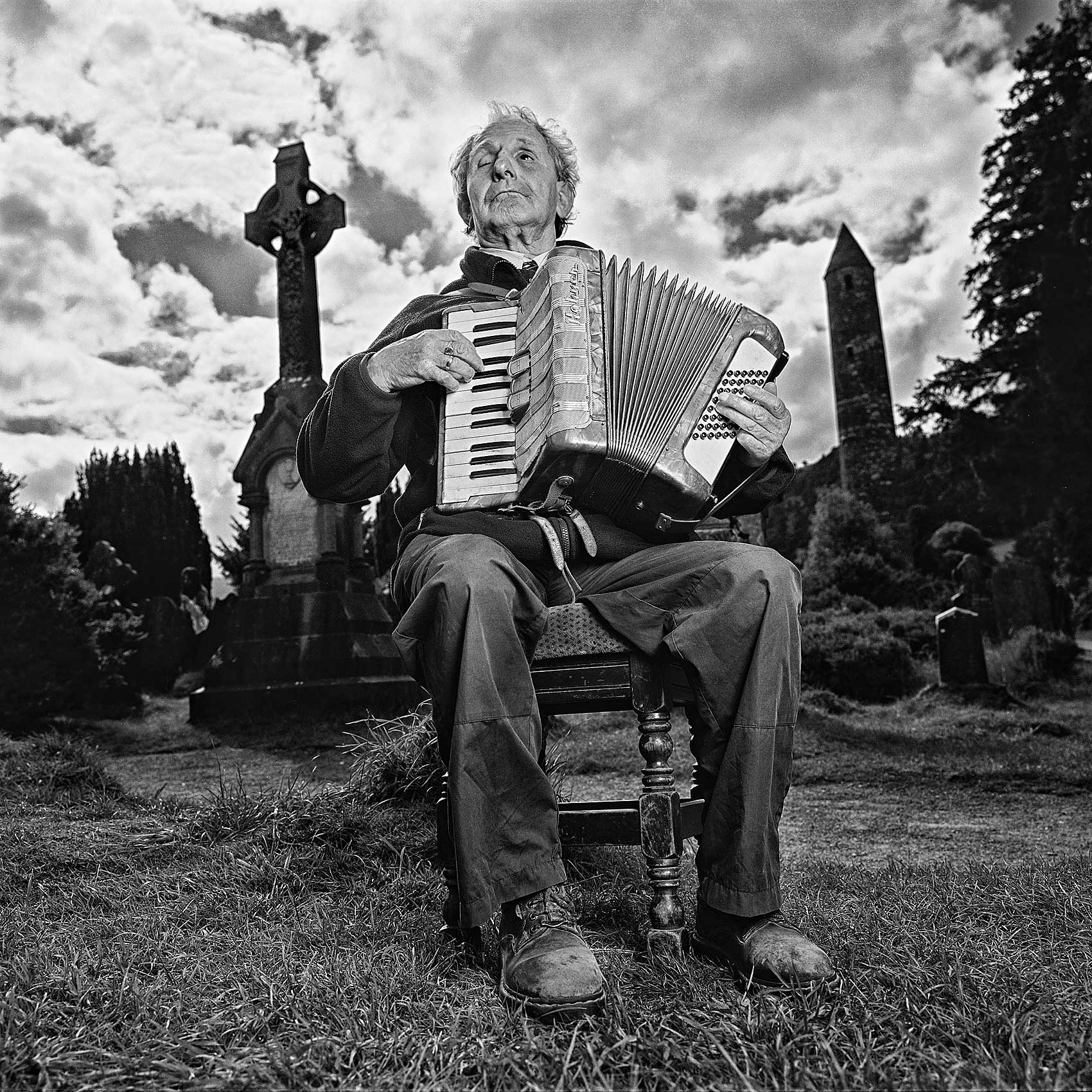 an-old-blind-irish-man-plays-the-accordion-in-a-graveyard