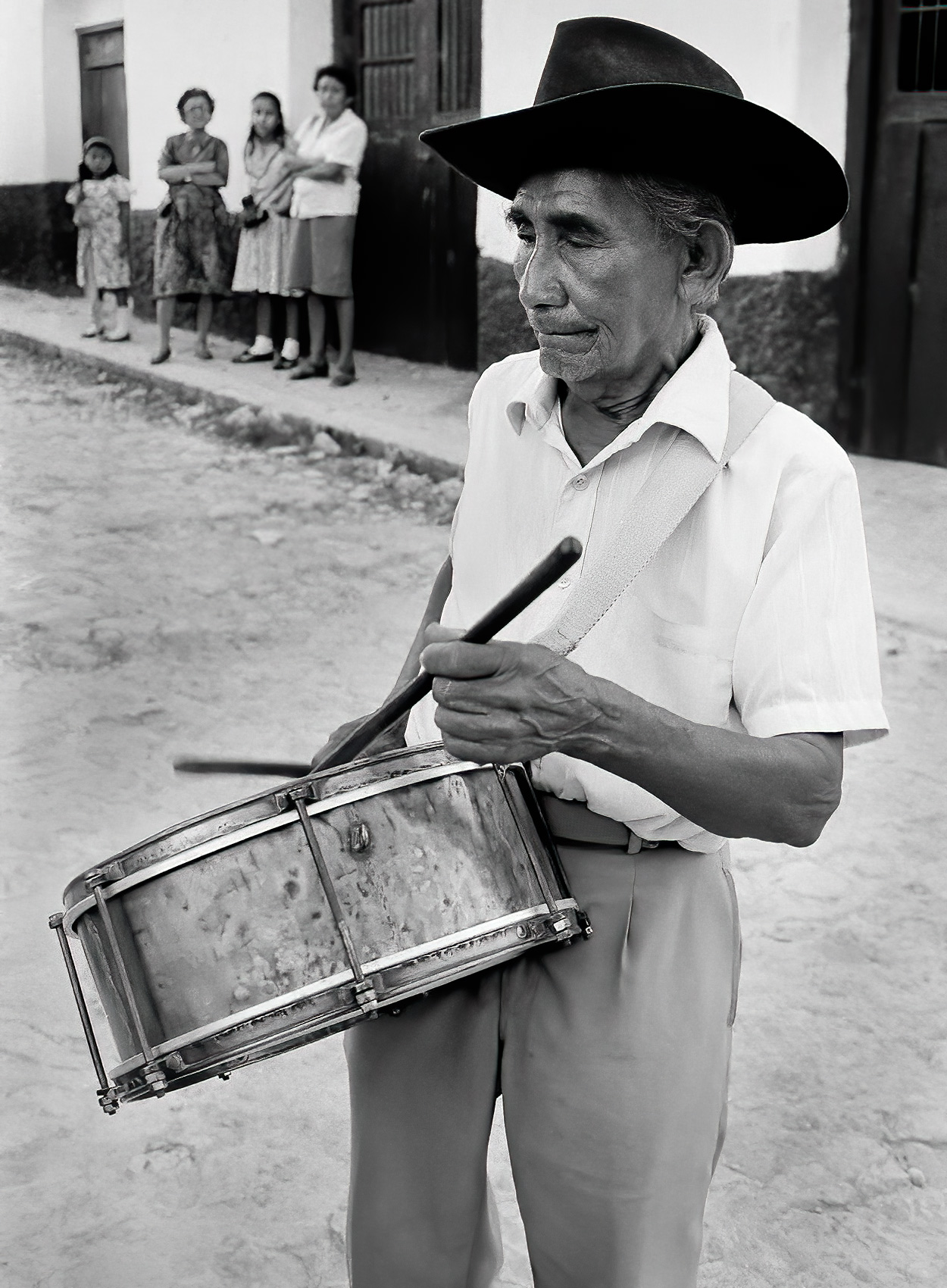 an-old-man-with-a-cowboy-hat-drums-on-the-streets-of-guatemala