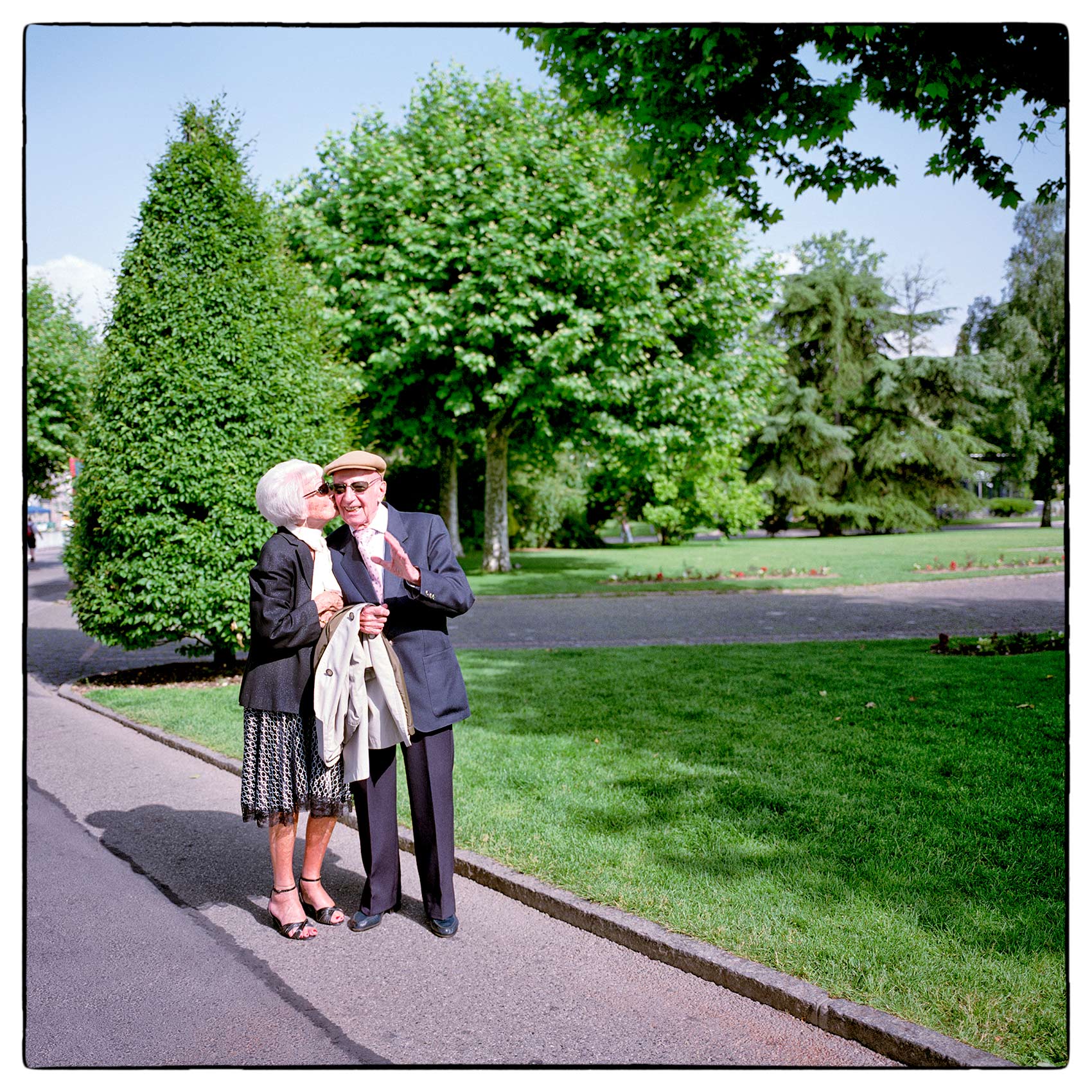 an-older-couple-enjoy-each-others-company-as-the-walk-through-a-park-in-geneva-switzerland