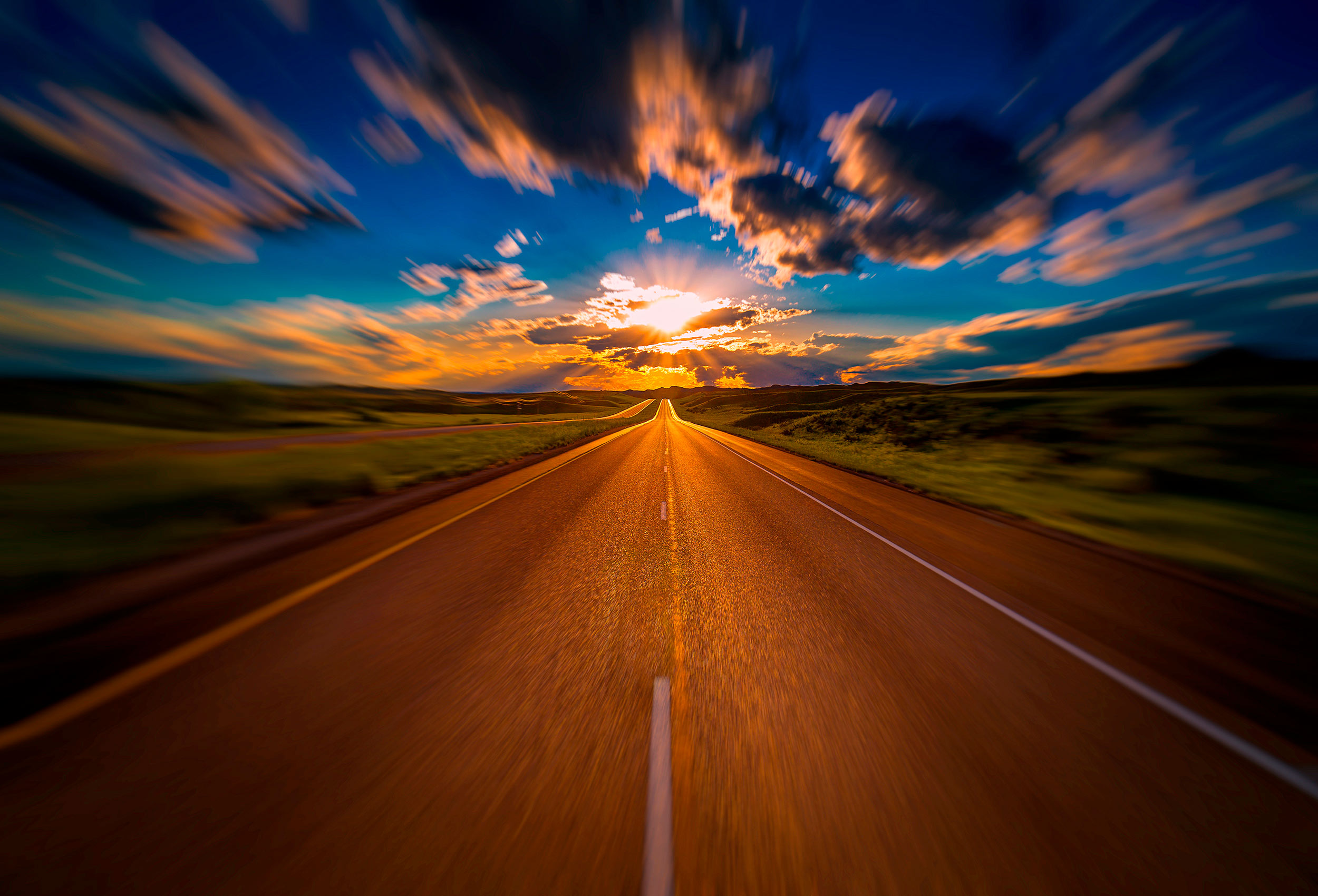 an incredible sun sets over a highway in south dakoka by an award winning travel photographer