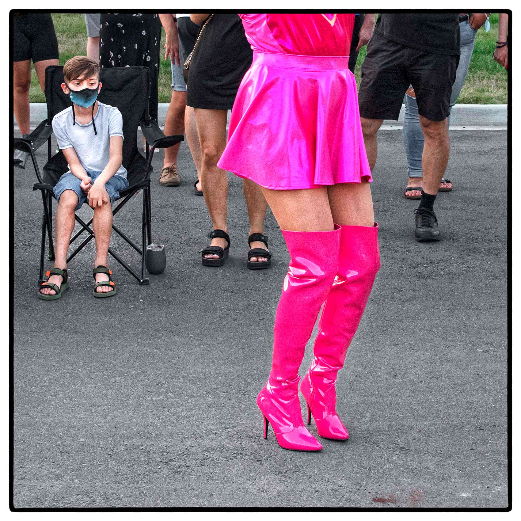 A young boy stares a drag queen by Toronto editorial photographer John Hryniuk 