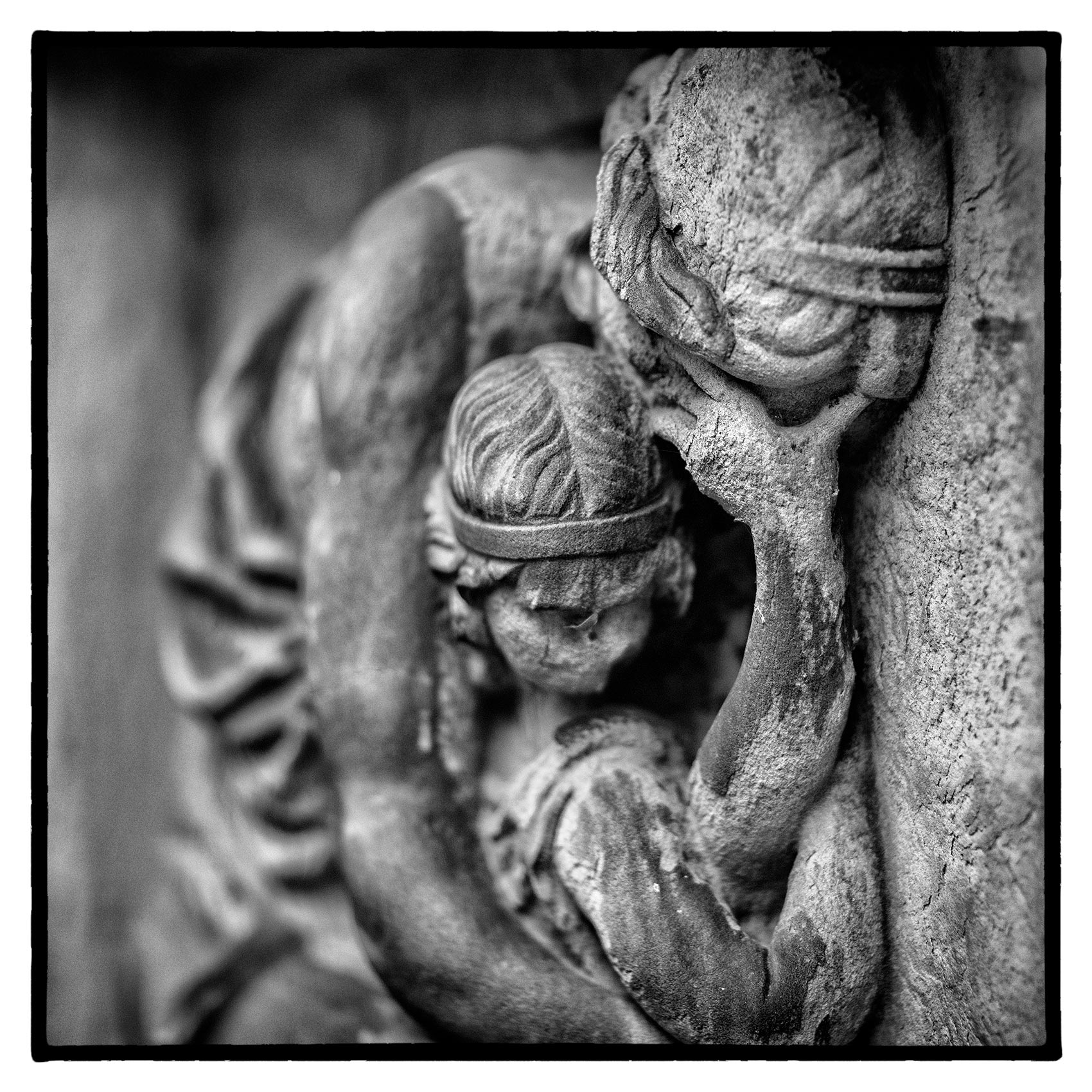 a stone sculpture of-crying mother and baby at St. James Cemetery in Toronto