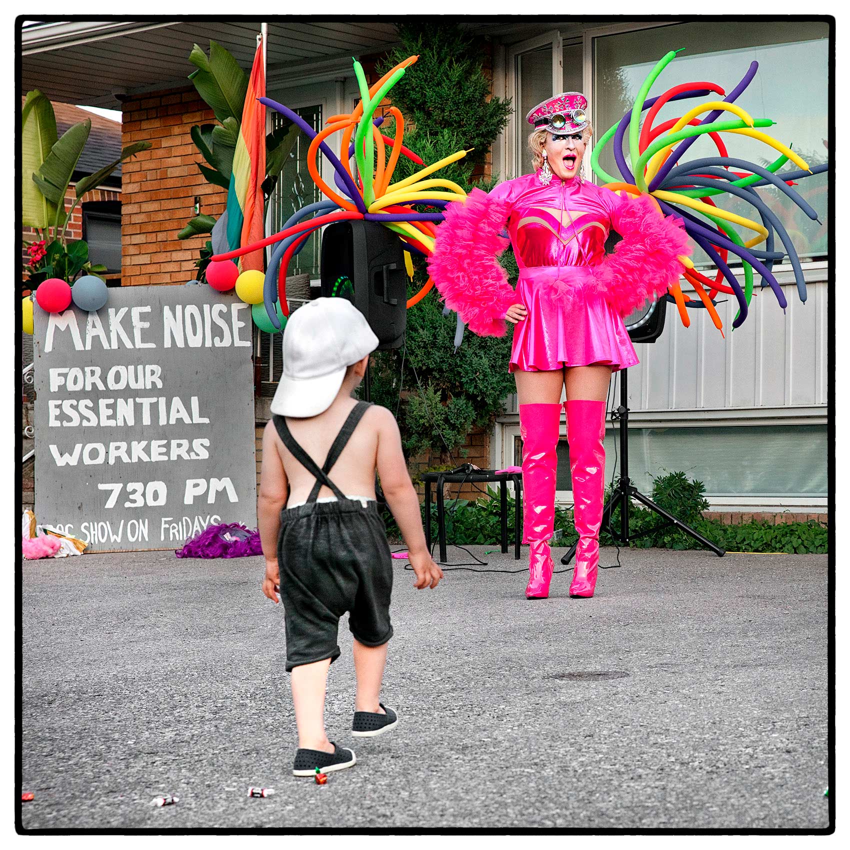 a young boy excitedly walks towards a drag queen in north york during the pandemic