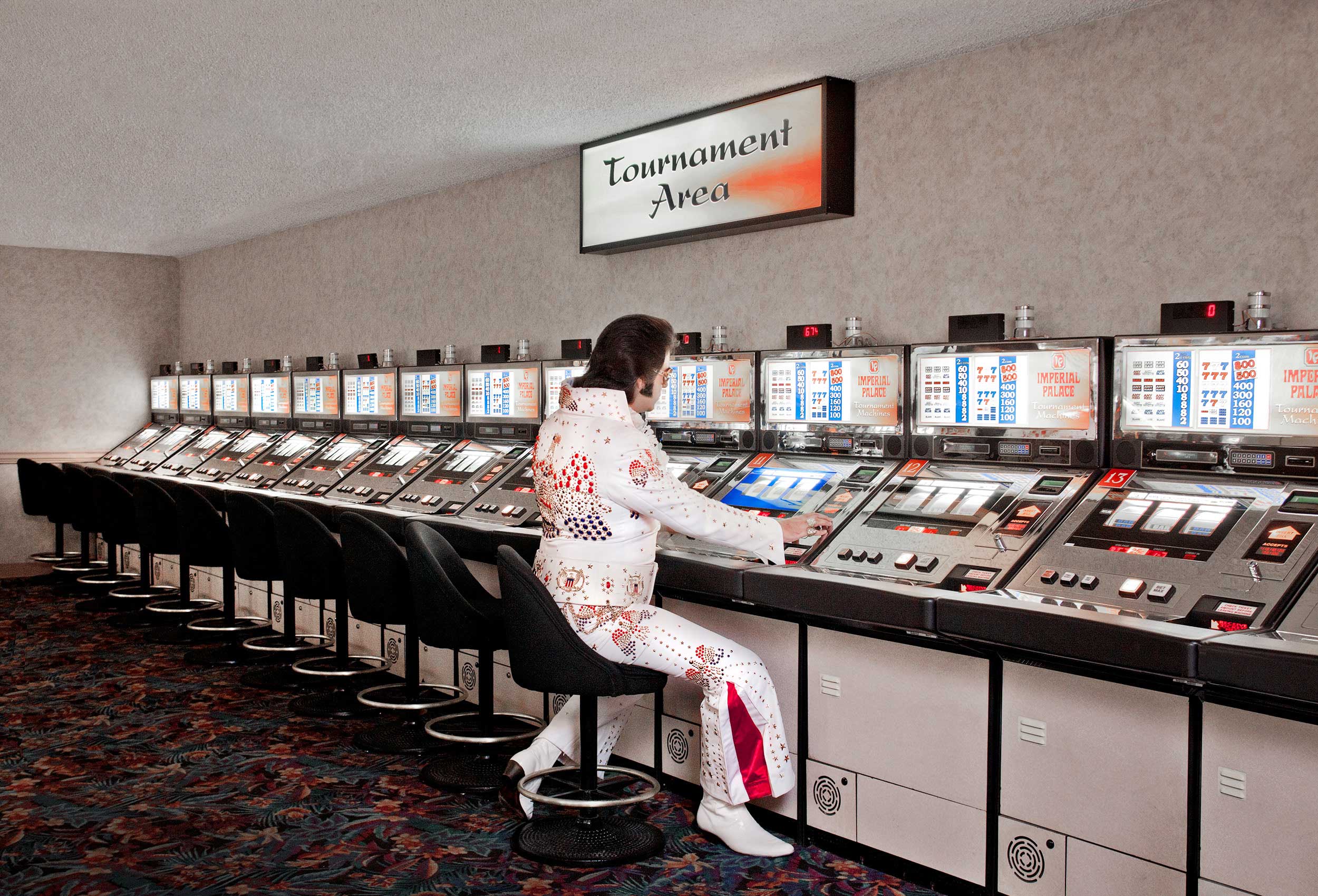 an elvis impersonator plays the slot machines in las vegas
