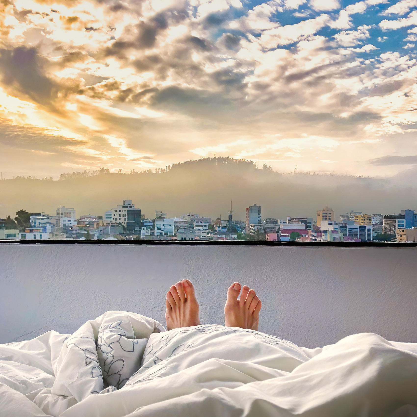a view of the beautiful morning sunrise overthe mountains in quito from an airbnb rental