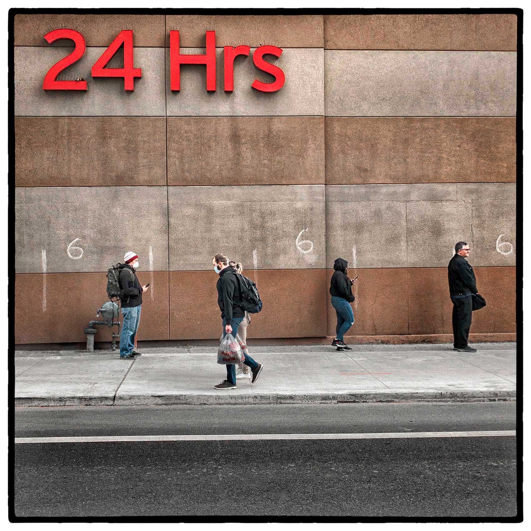 shoppers socially distance as they wait in line outside a toronto grocery store during the pandemic