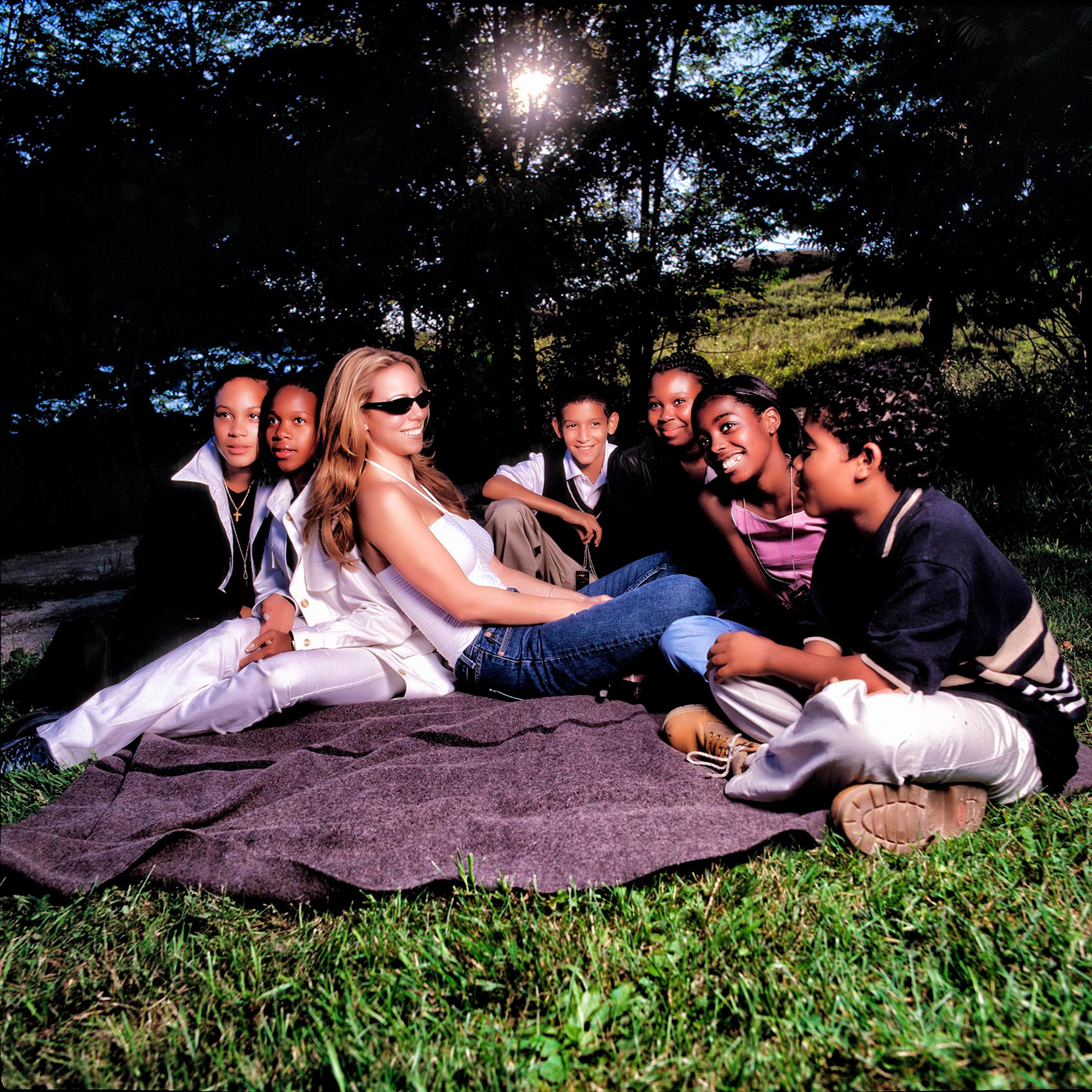 mariah carey sits outside for a picnic with at street youth while filming in toronto